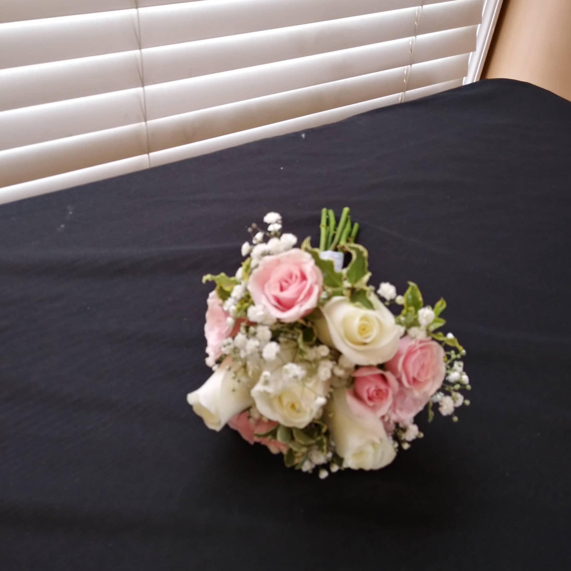 Small bouquet of pink and white roses with baby's breath