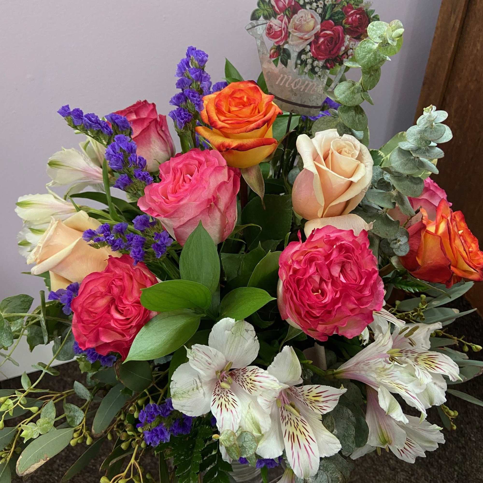 A beautiful mix of roses, alstroemeria, statice, and greens to show how