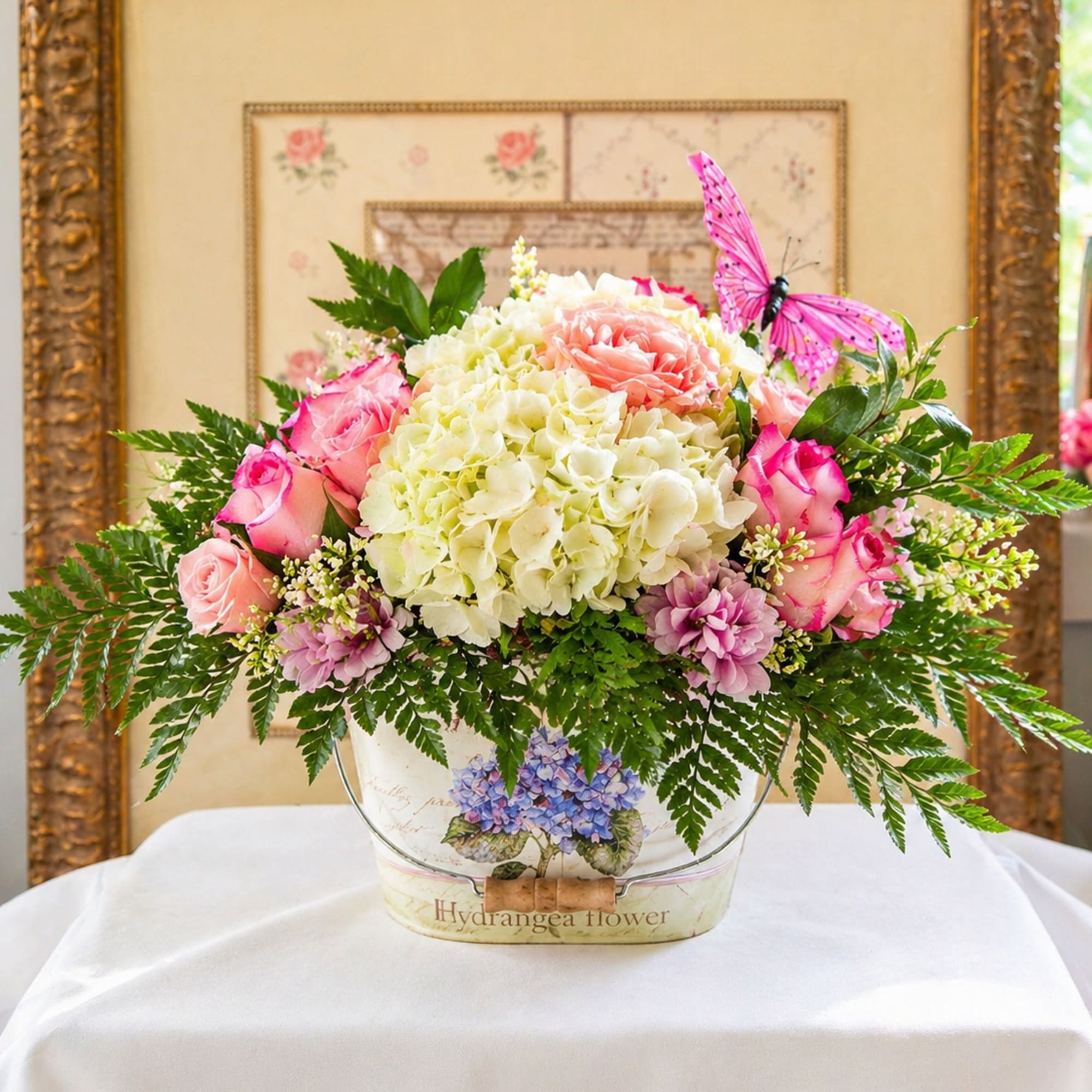 Layered shades of pink roses nestle against a generous mound of creamy