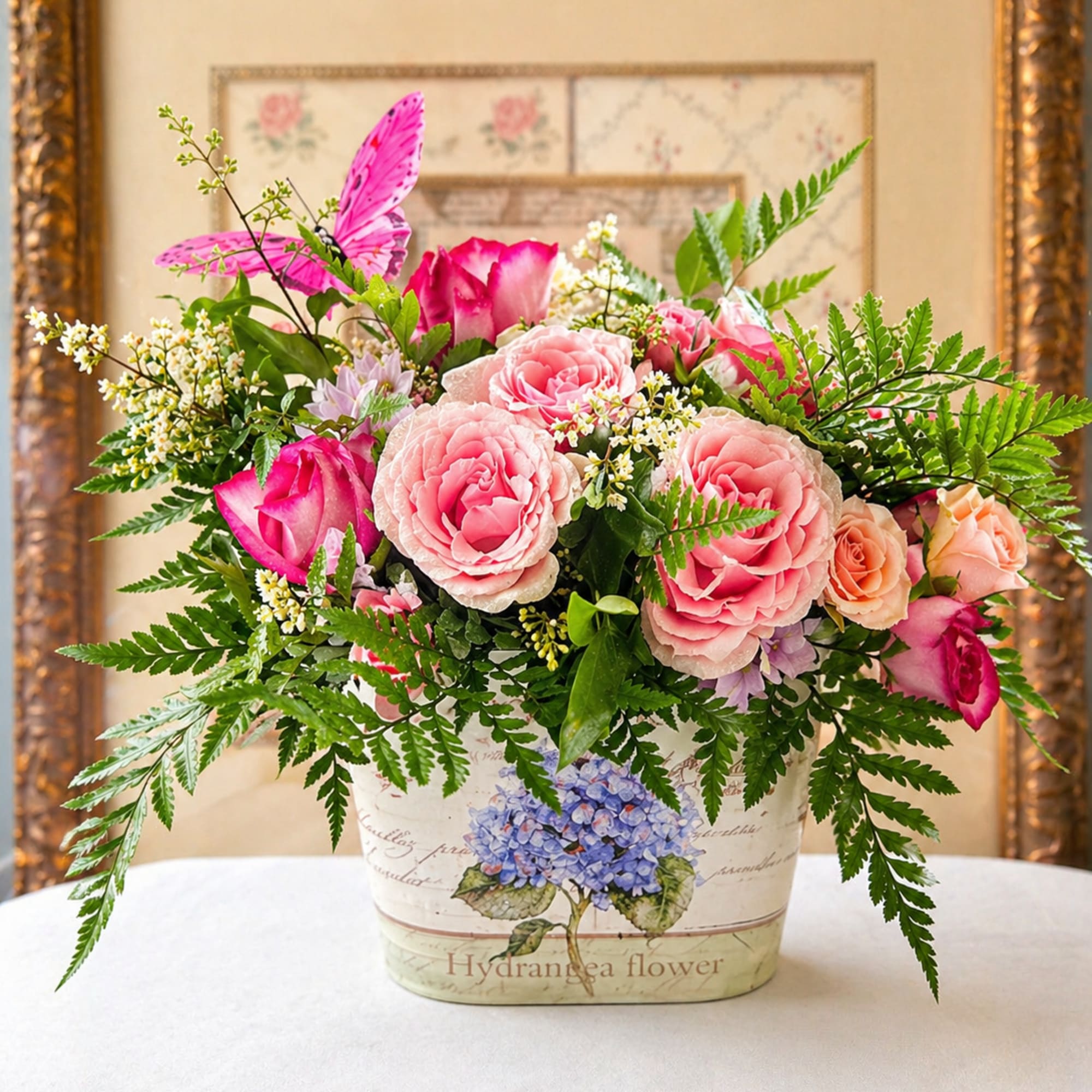 Layered shades of pink roses nestle against a generous mound of creamy