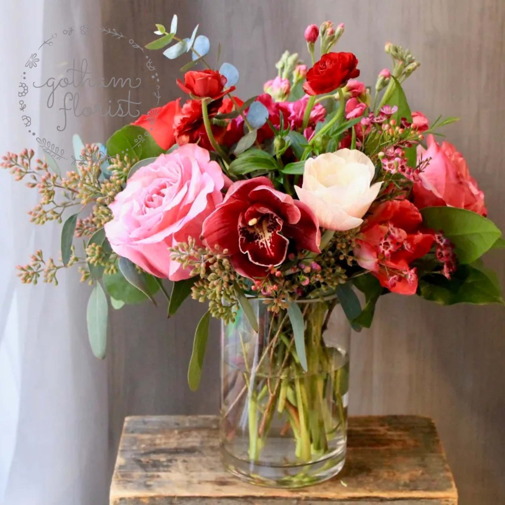 Bouquet of pink and red flowers in a clear glass vase