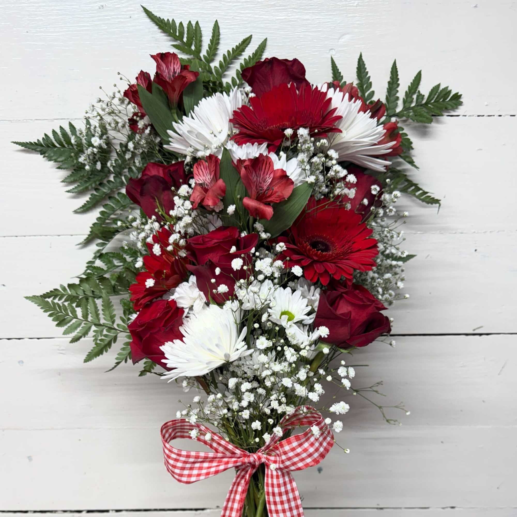 Red and white mixed flower bouquet with a gingham ribbon