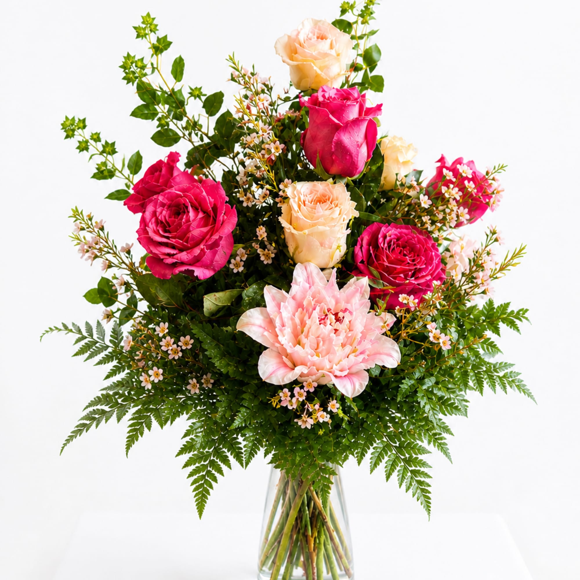 Lush clusters of hot pink and peach roses surround a large pale-pink