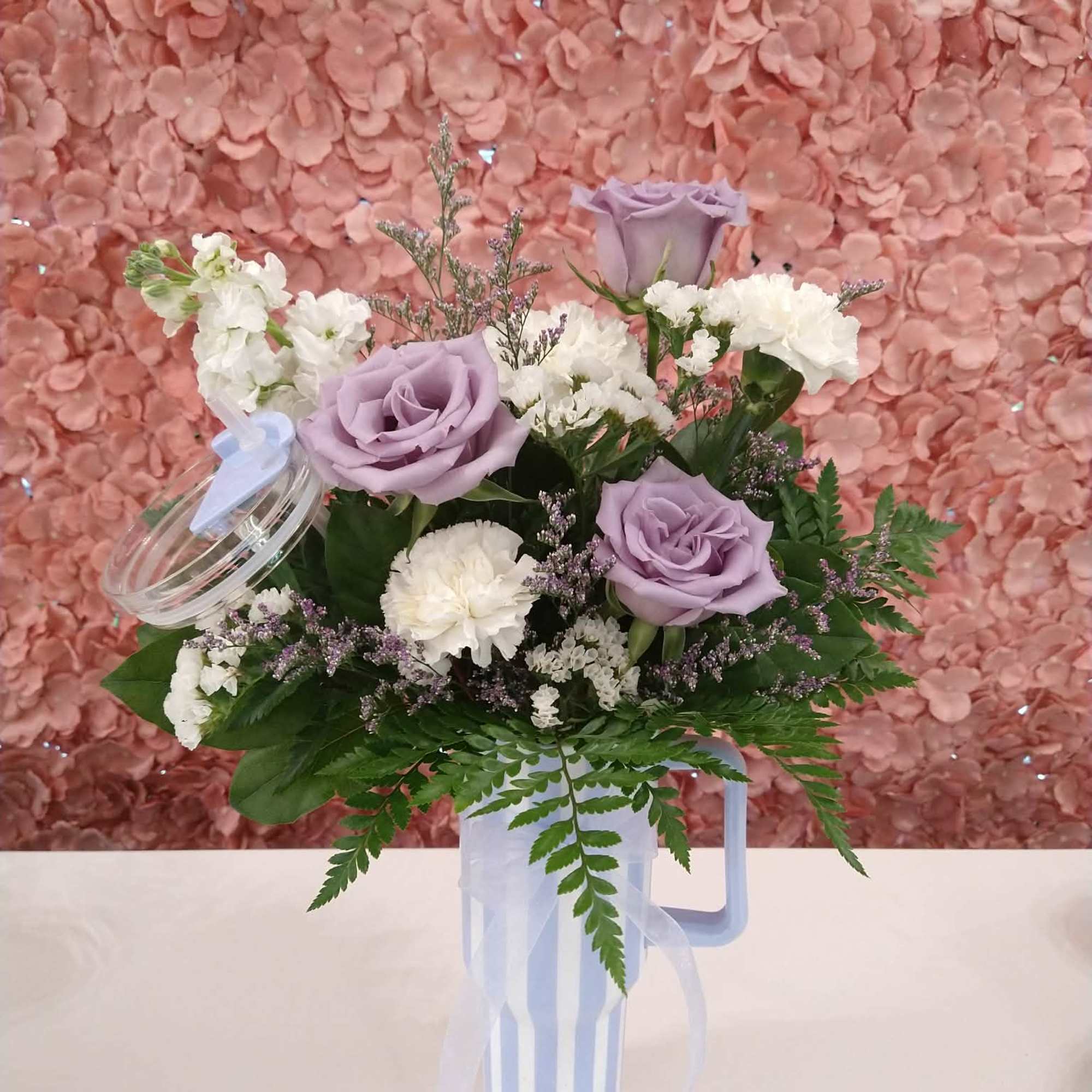 An assortment of florals in a sturdy tumbler with a lid and