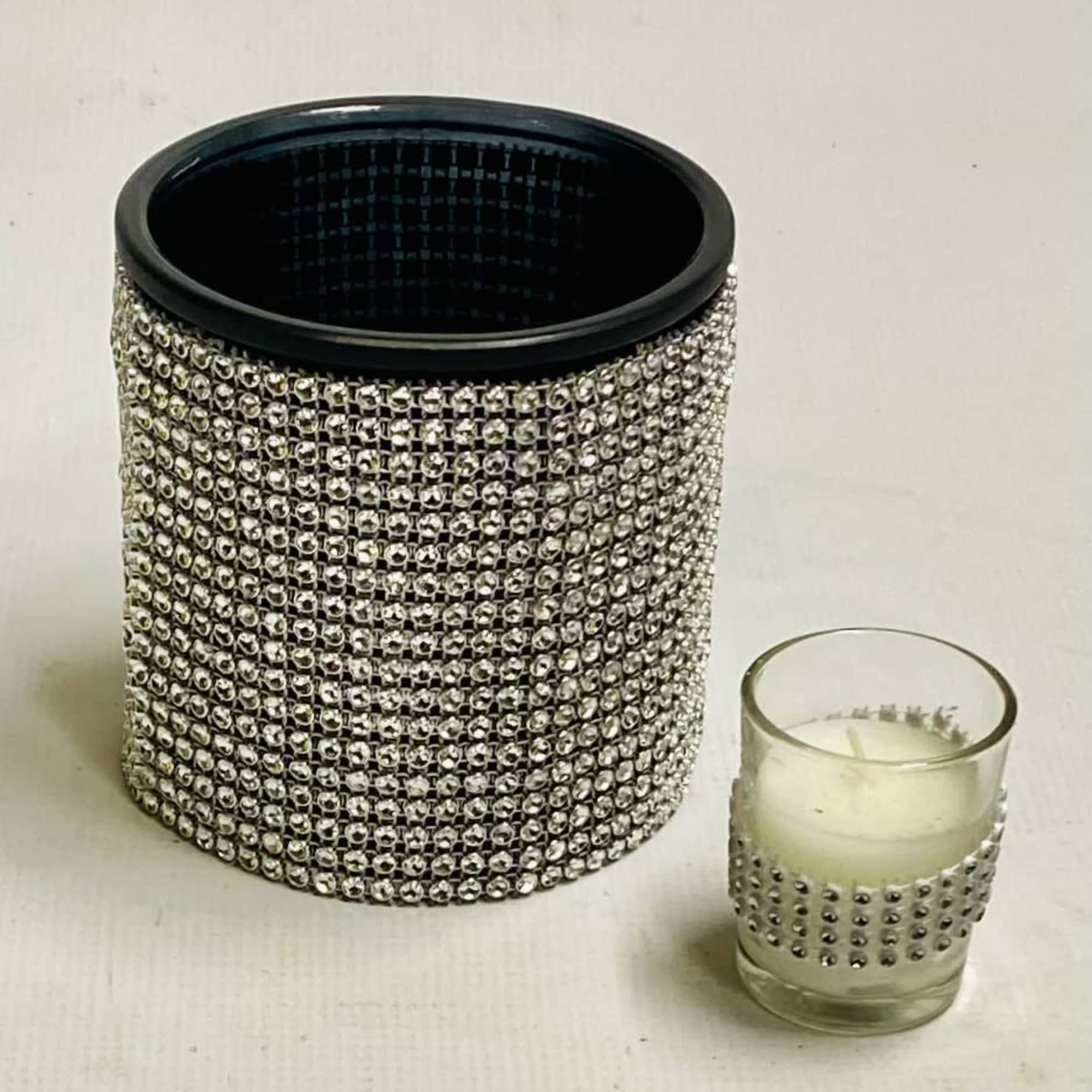 Rhinestone-covered black container and small glass candle holder