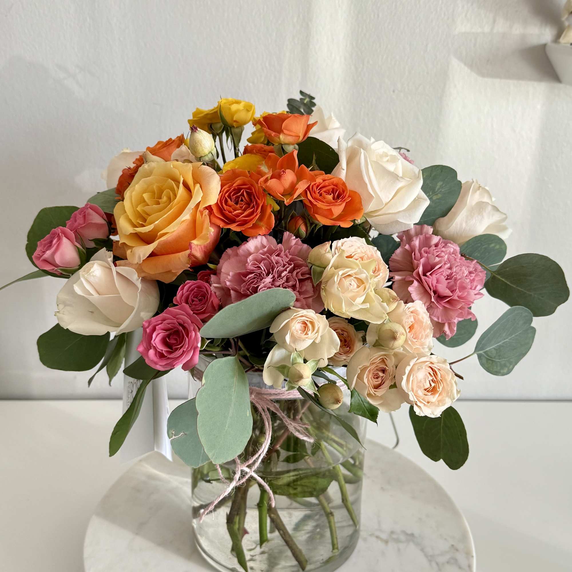 Mixed roses and carnations in a glass vase