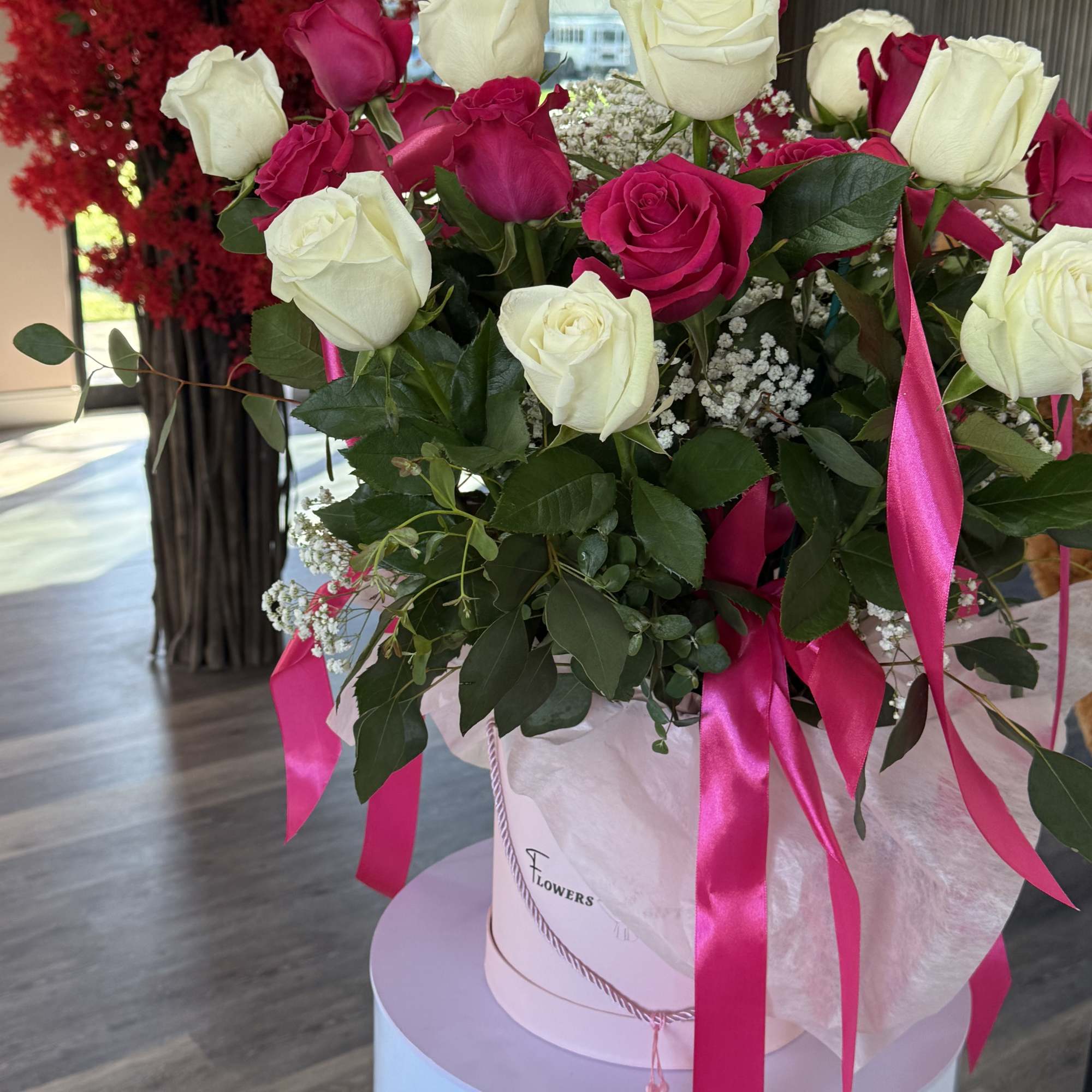 A lush dome of white and hot-pink roses makes an immediate impression-this