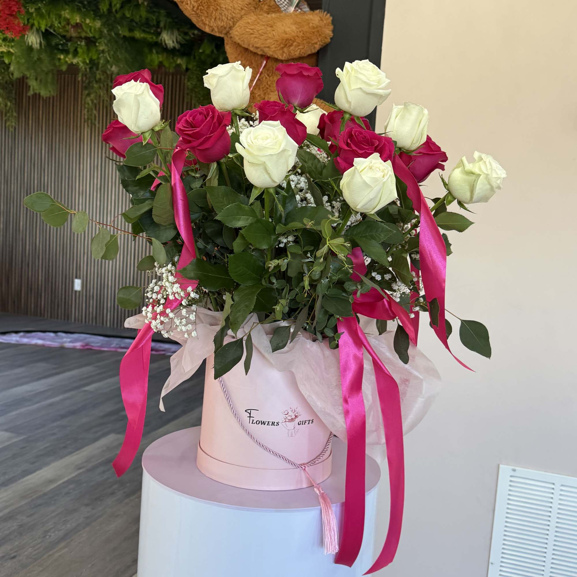 A lush dome of white and hot-pink roses makes an immediate impression-this