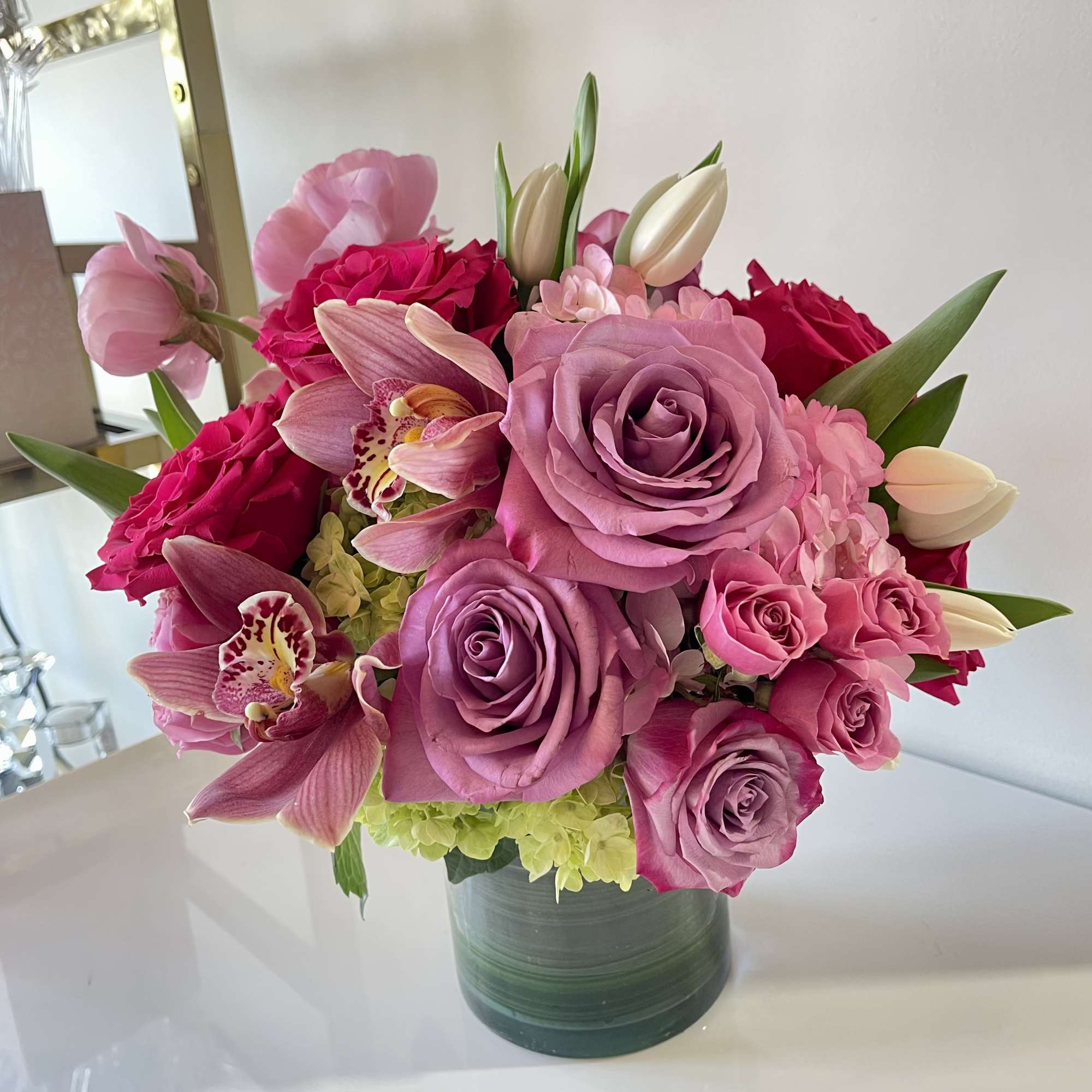 A lush, romantic arrangement overflowing with soft pinks and vibrant fuchsia tones.
