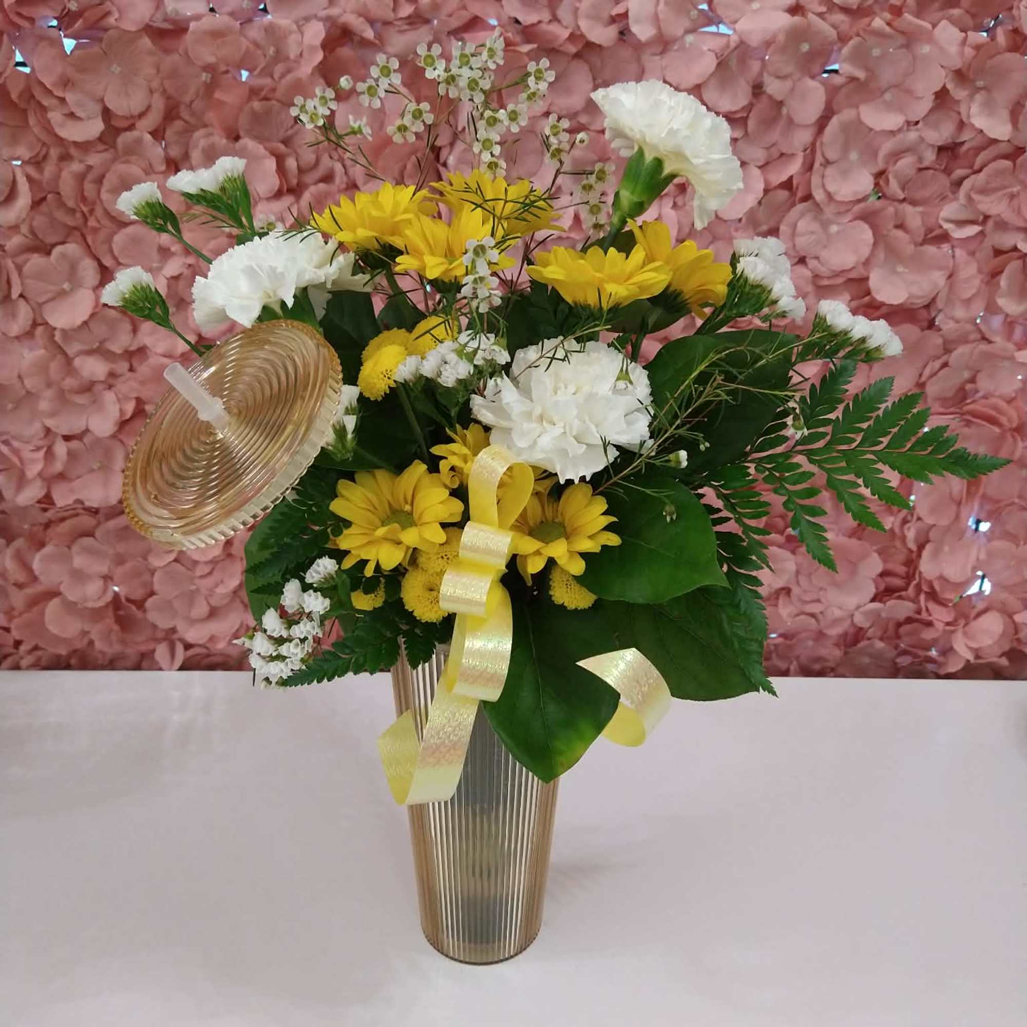 An assortment of florals in a sturdy tumbler with a lid and