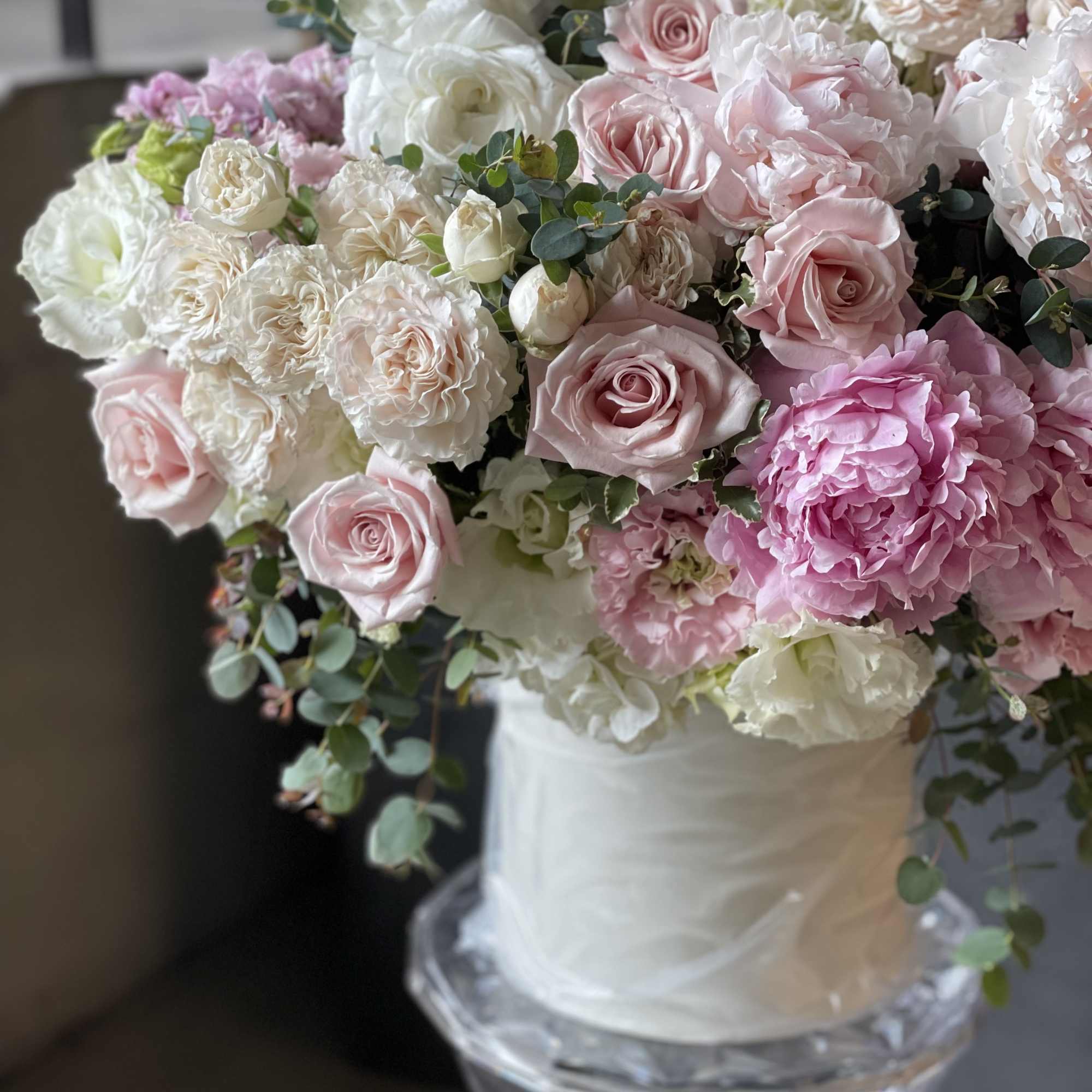 Pink and white rose bouquet in a white vase