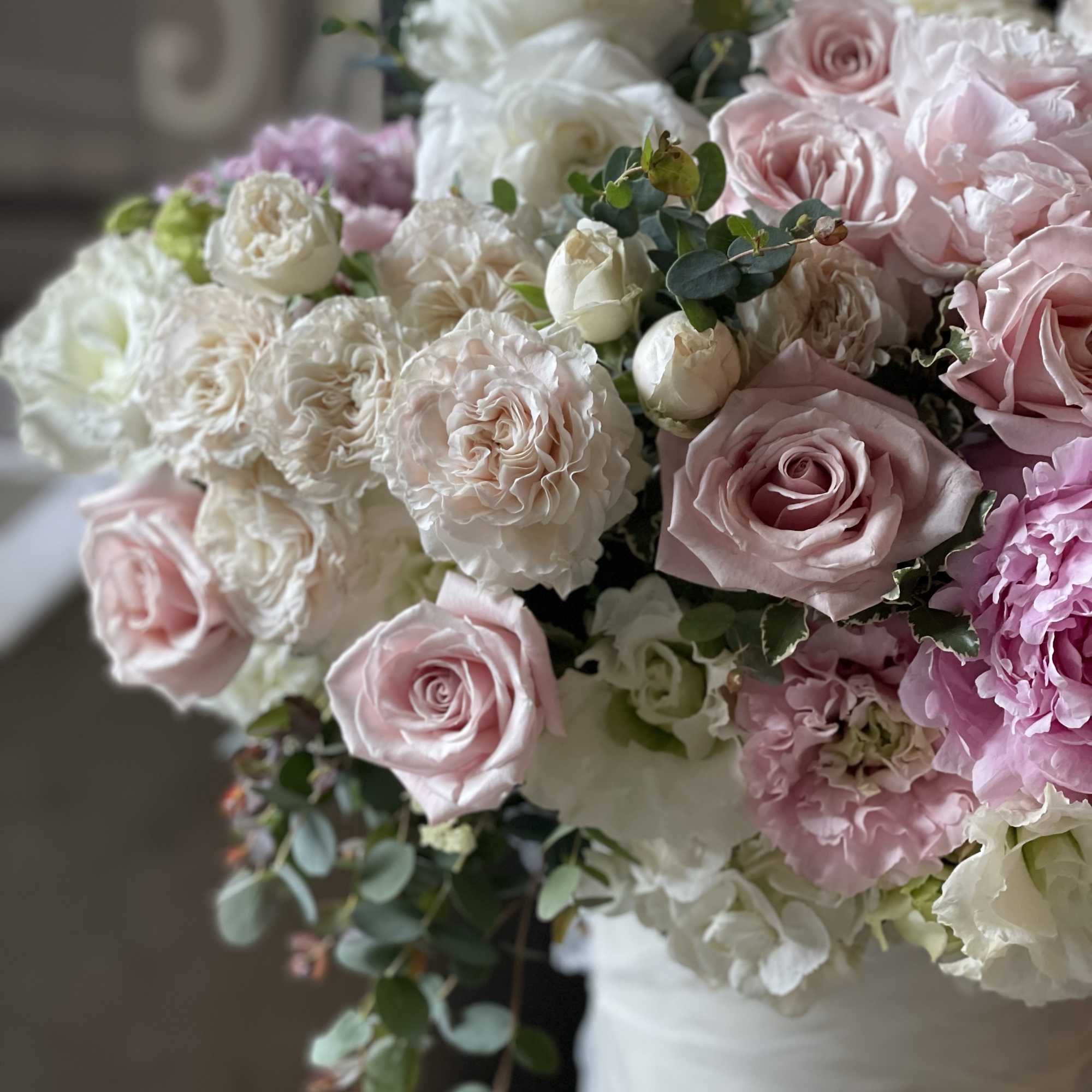 Bouquet of pink and white roses with soft greenery