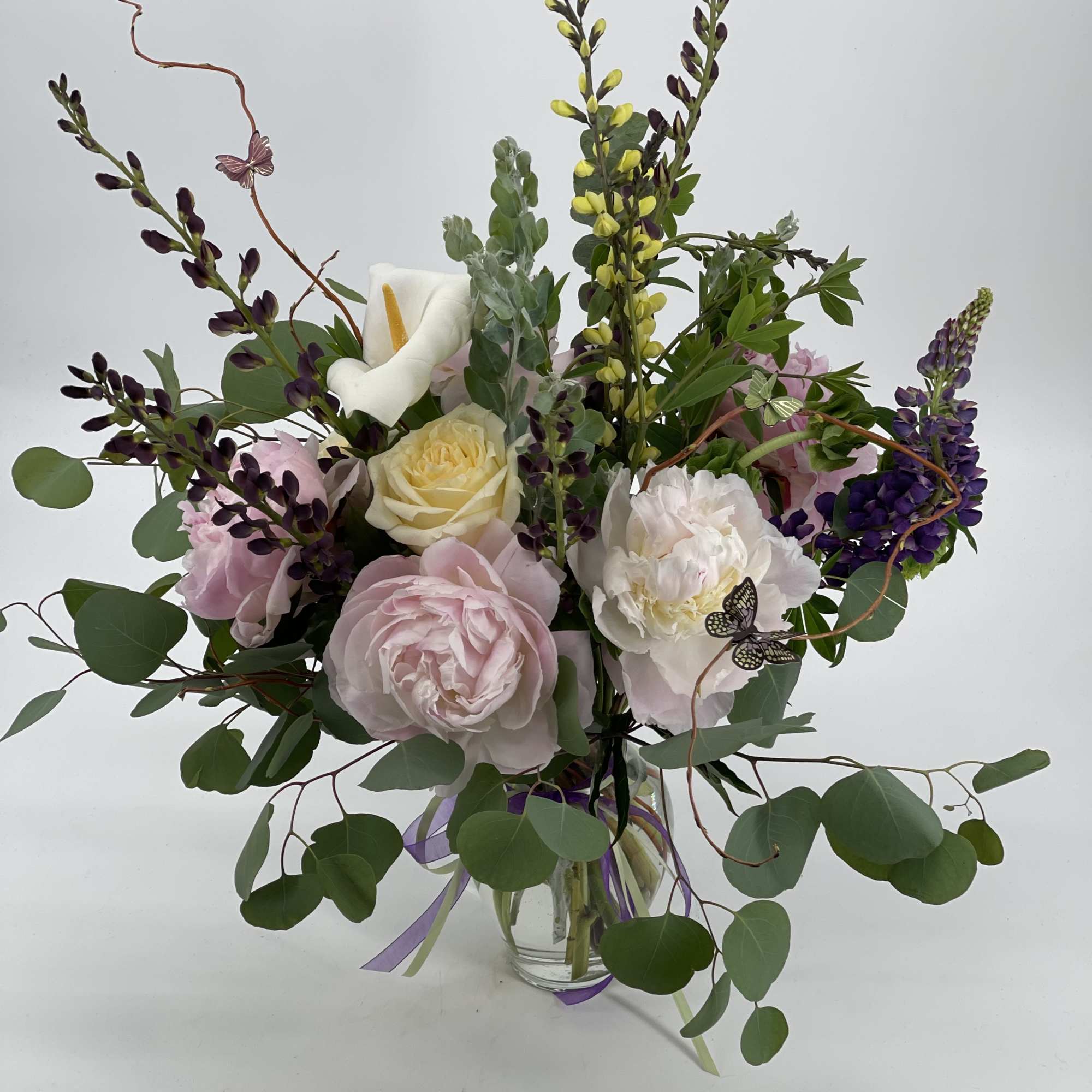 Mixed bouquet of pink and white flowers in a clear glass vase