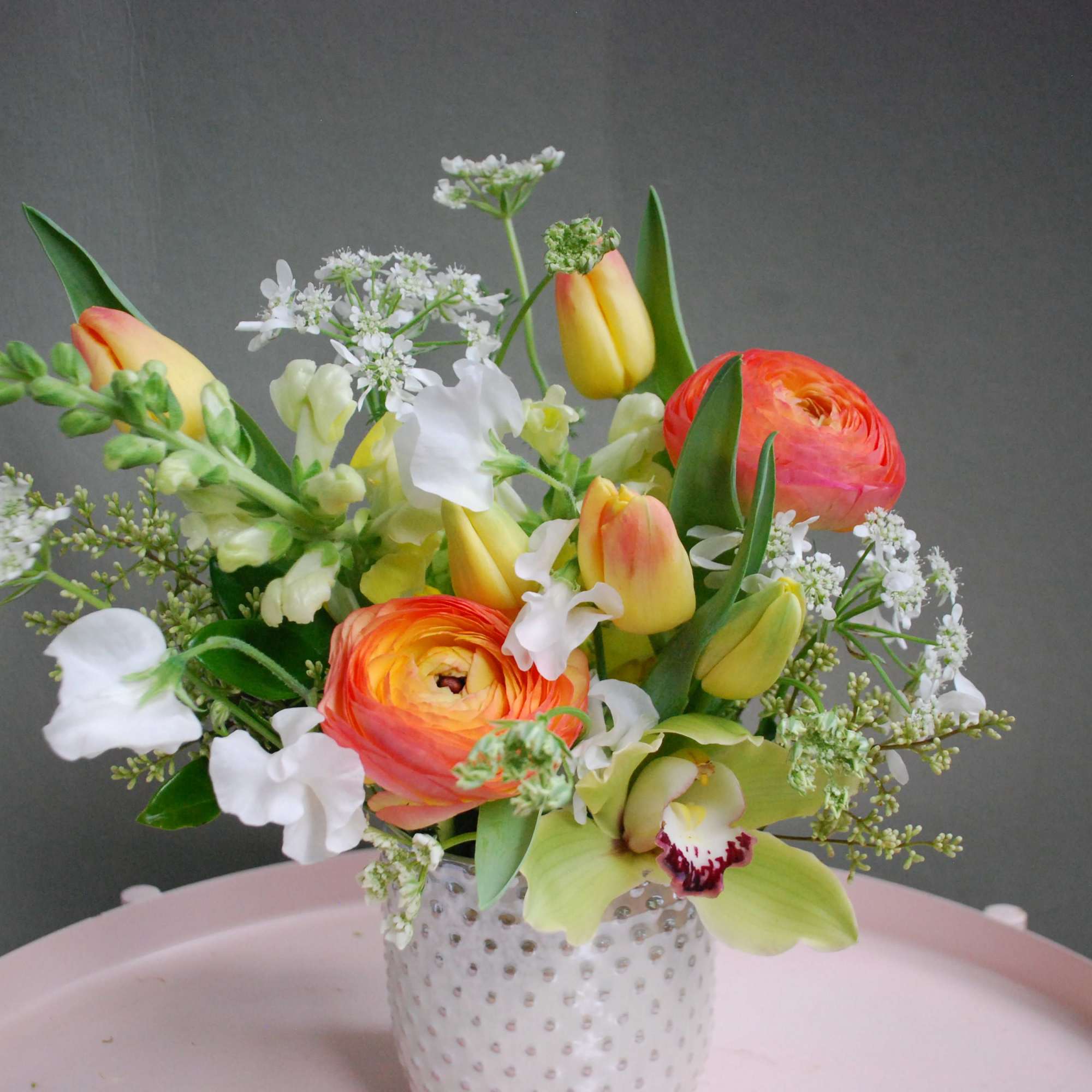 Bold, sculptural and joyfully colorful, this floral arrangement-perfect as a birthday bouquet
