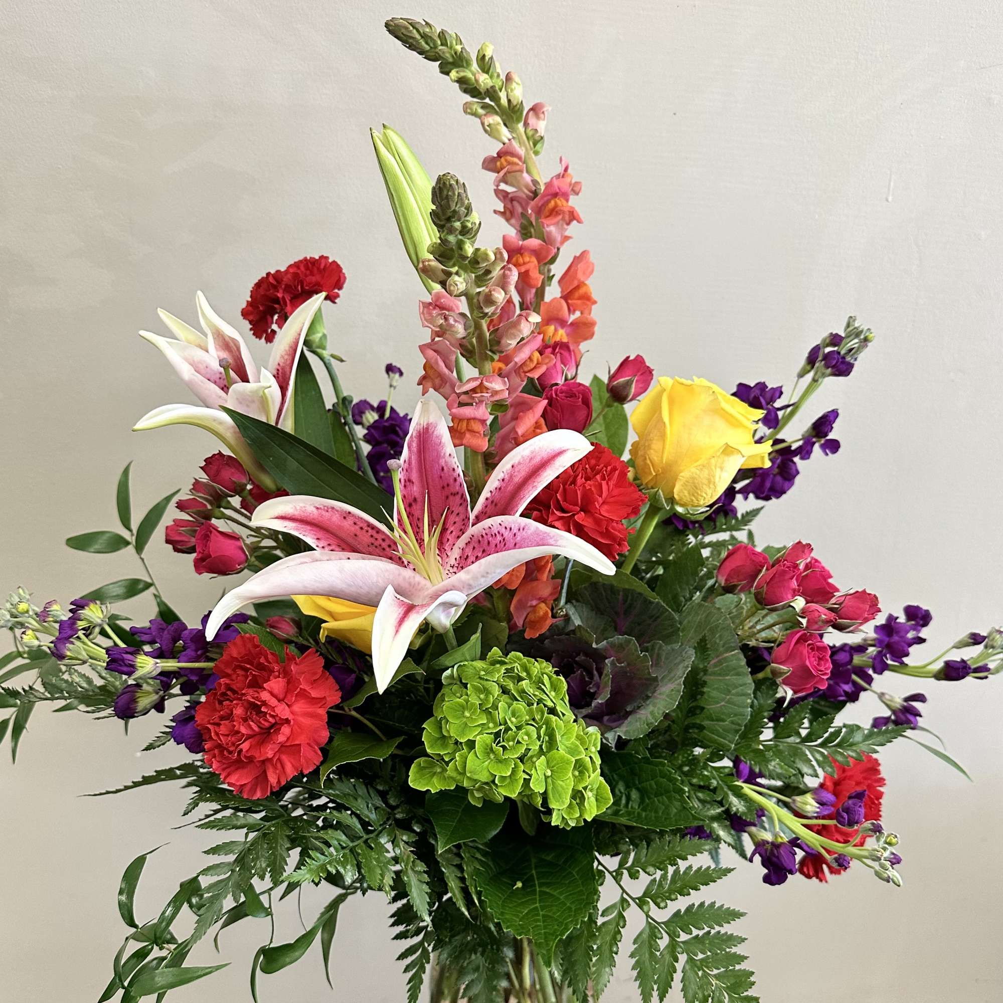 Colorful bouquet with lilies, roses, carnations, and snapdragons