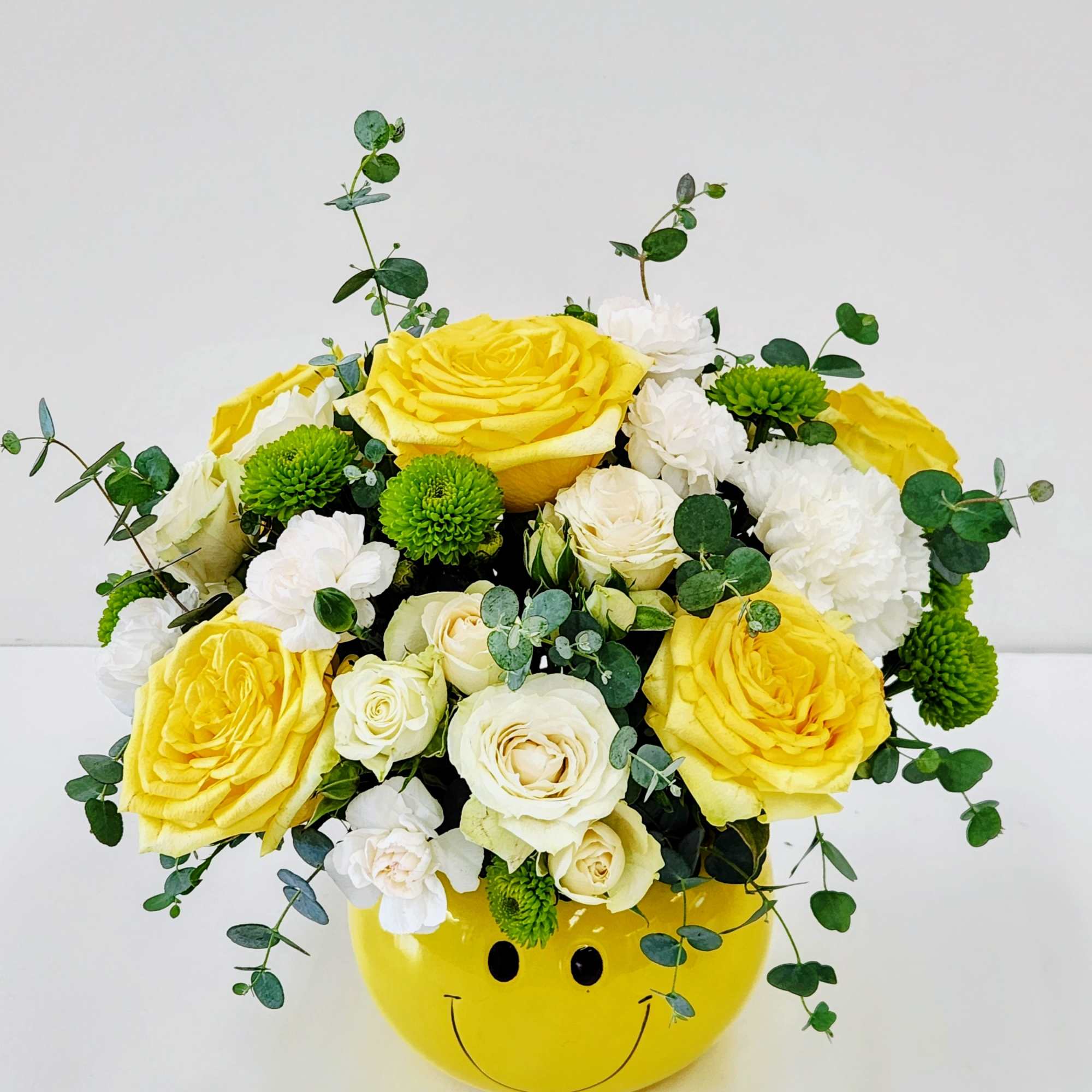 Sunny yellow roses and crisp white blooms tucked into a playful yellow