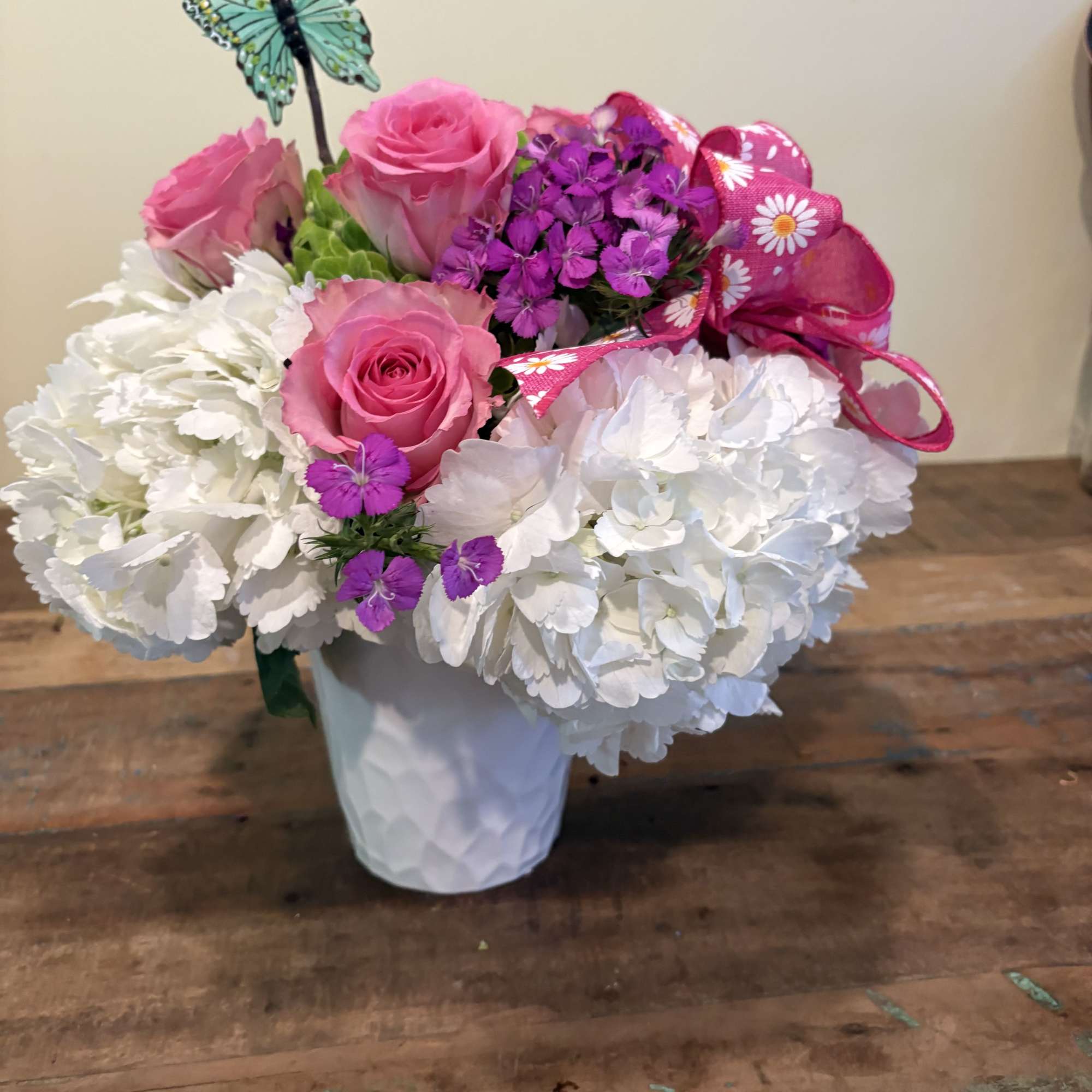 Assorted hydrangea with pink roses, dianthus and a butterfly