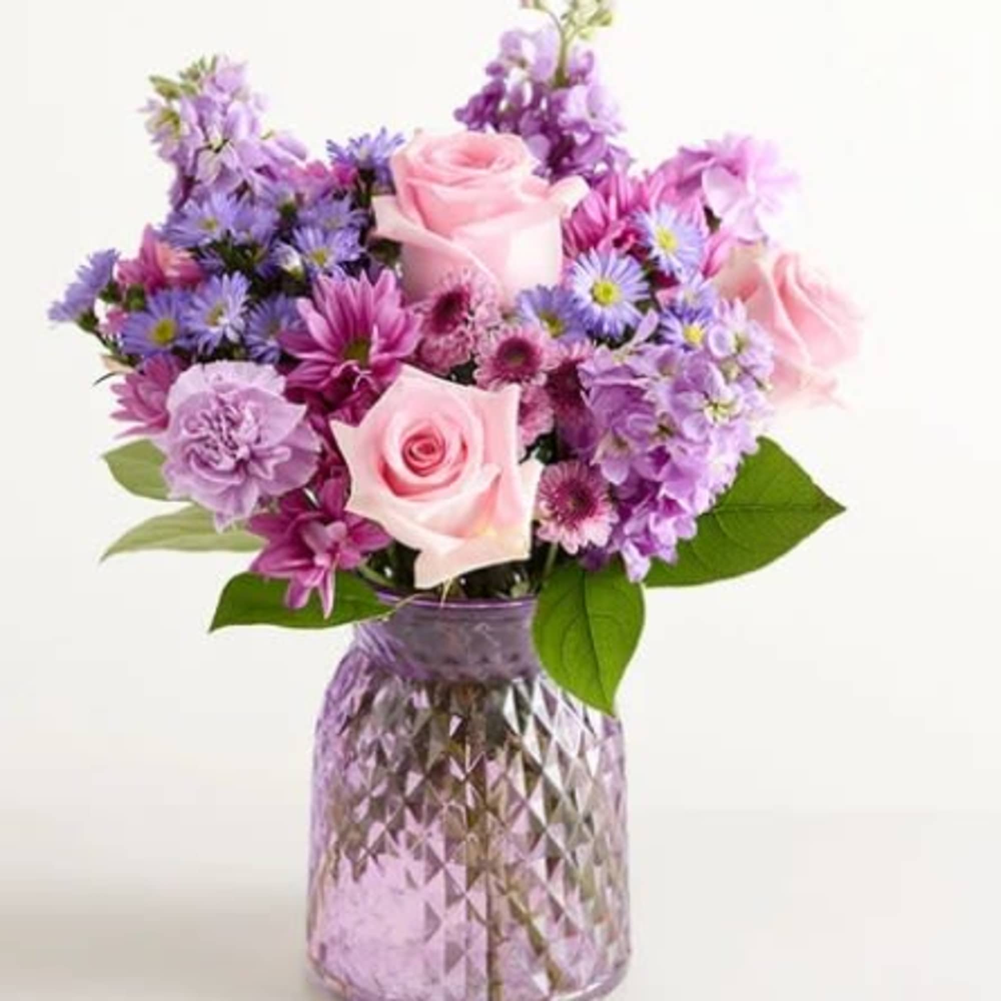 Soft pink roses with lavender and purple daisies, carnations, asters and mums