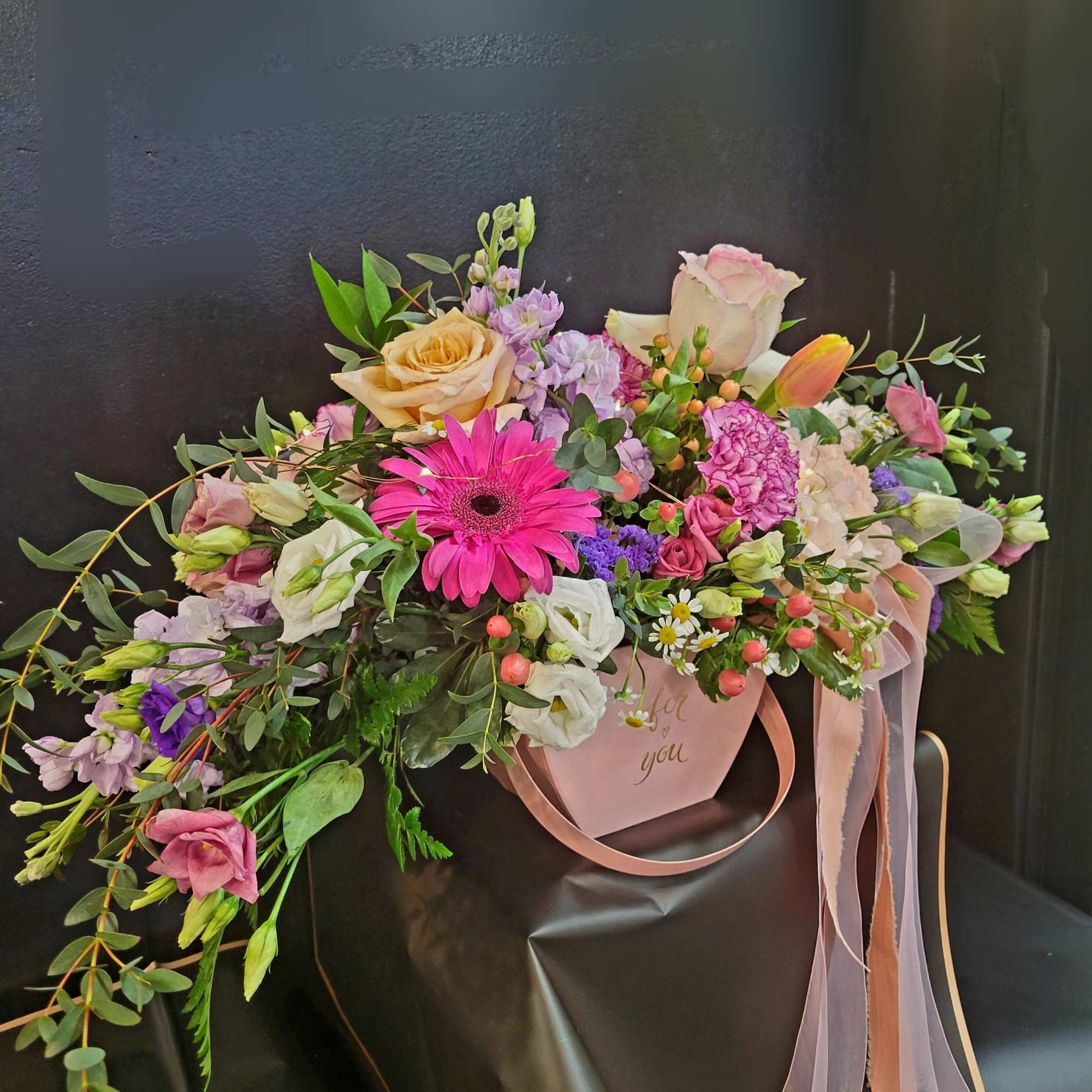 Mixed bouquet in a pink gift box with ribbon handles
