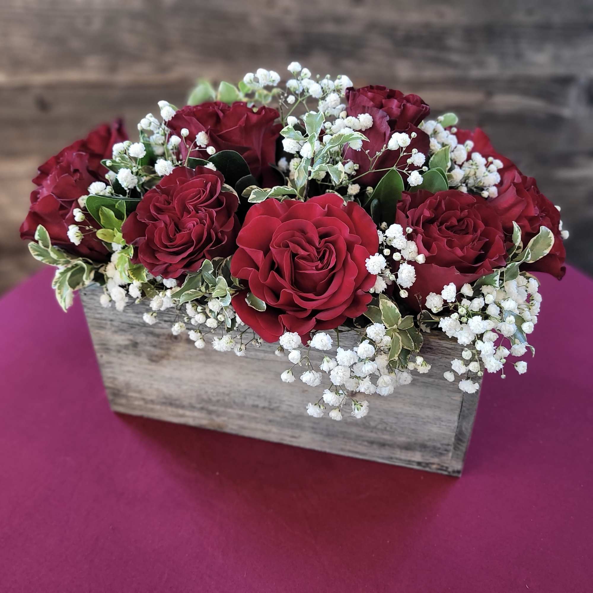 Lovely roses in a rectangular box with filler flowers and greenery. A