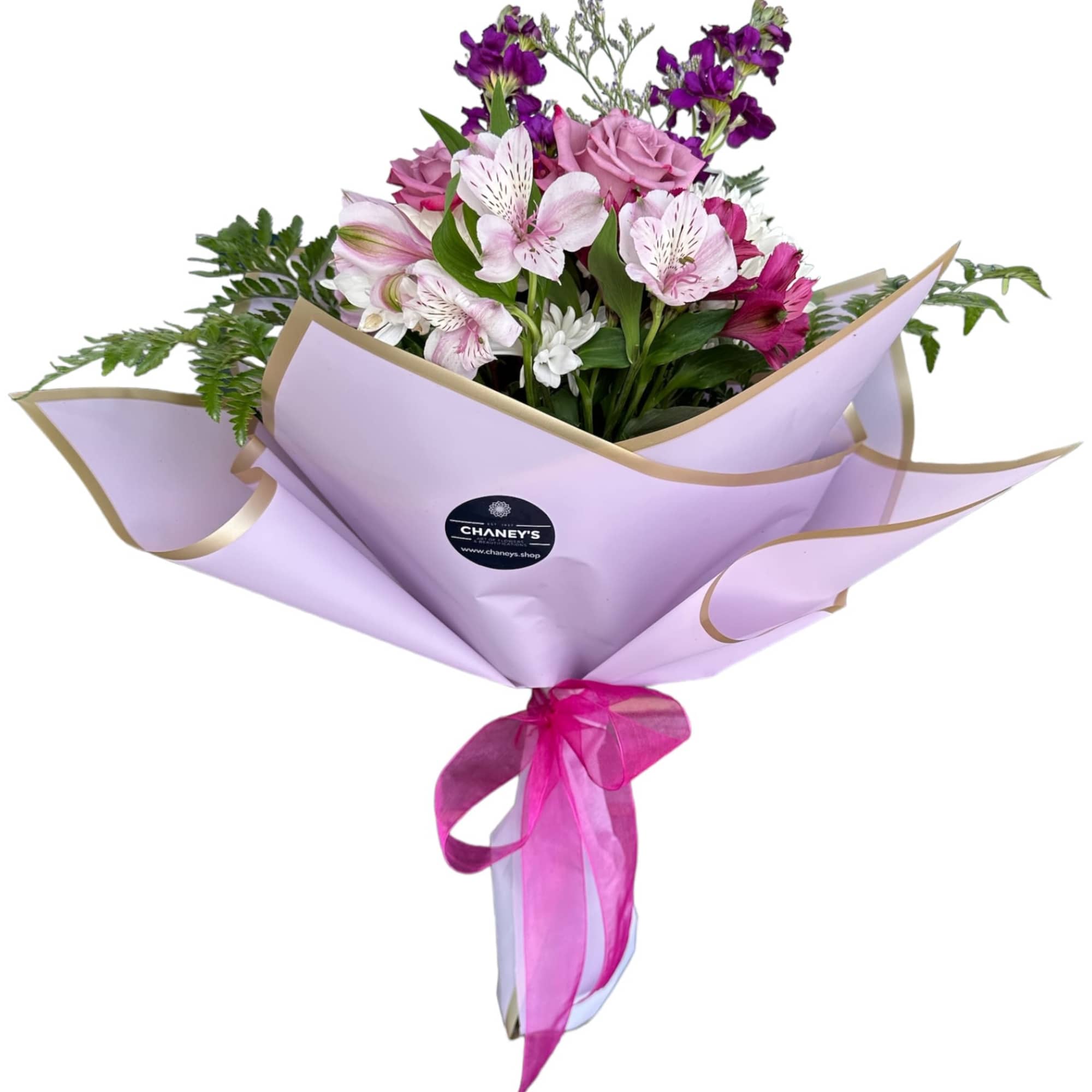 Bouquet of pink and purple flowers wrapped in lavender paper with a ribbon