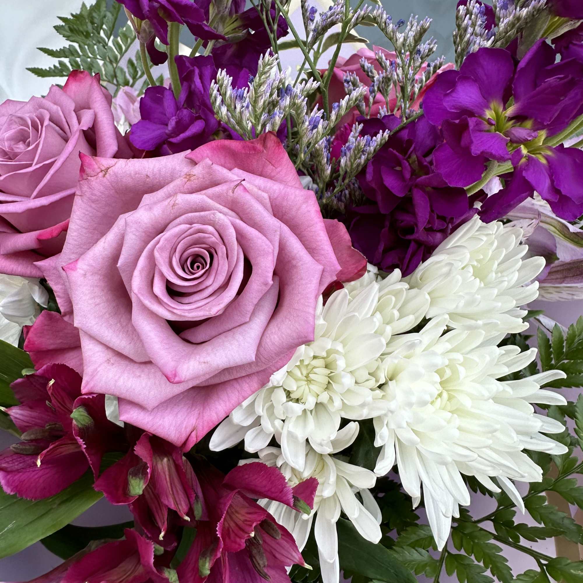 Bouquet of pink roses, white chrysanthemums, and purple flowers