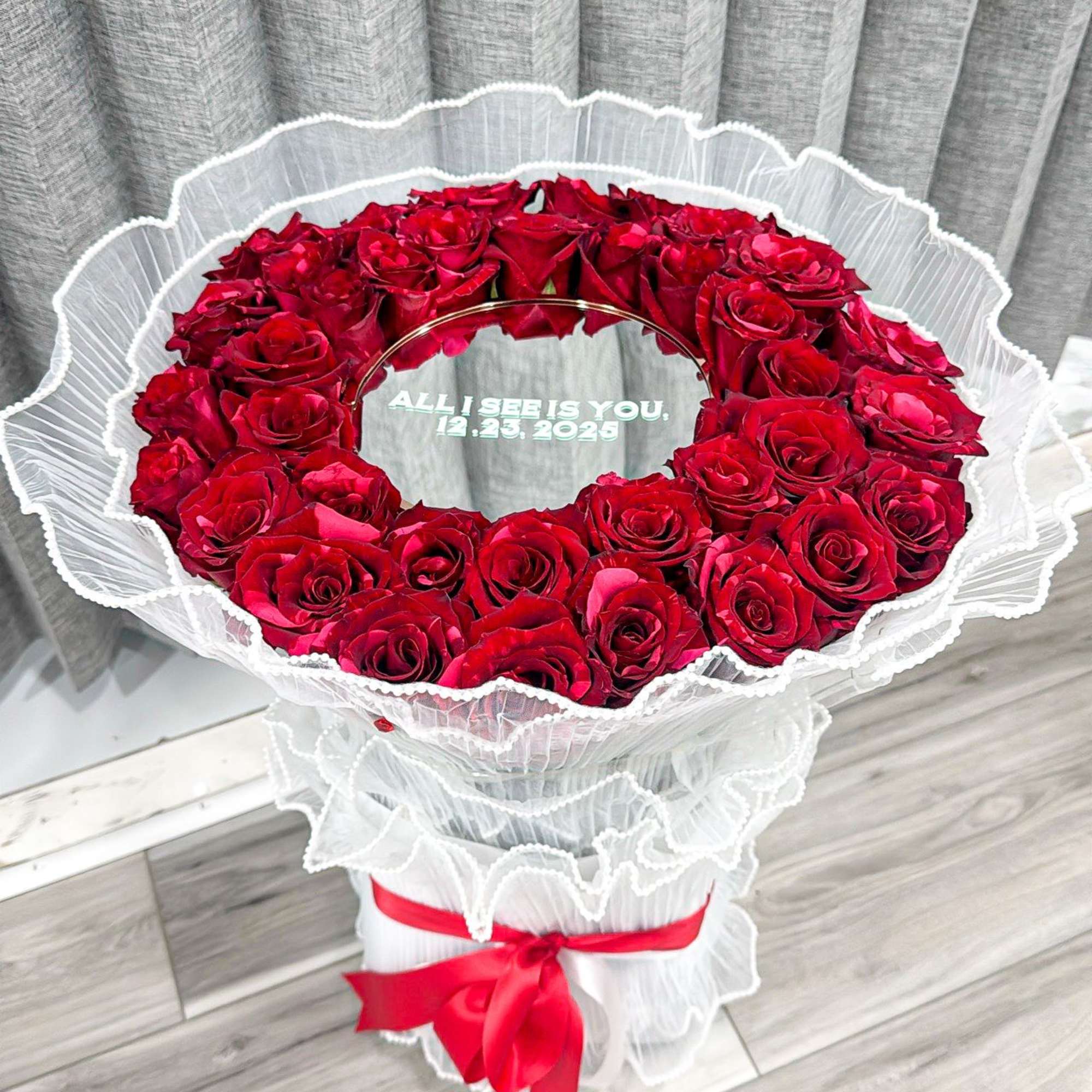 A dramatic ring of deep red roses arranged in a perfect circular