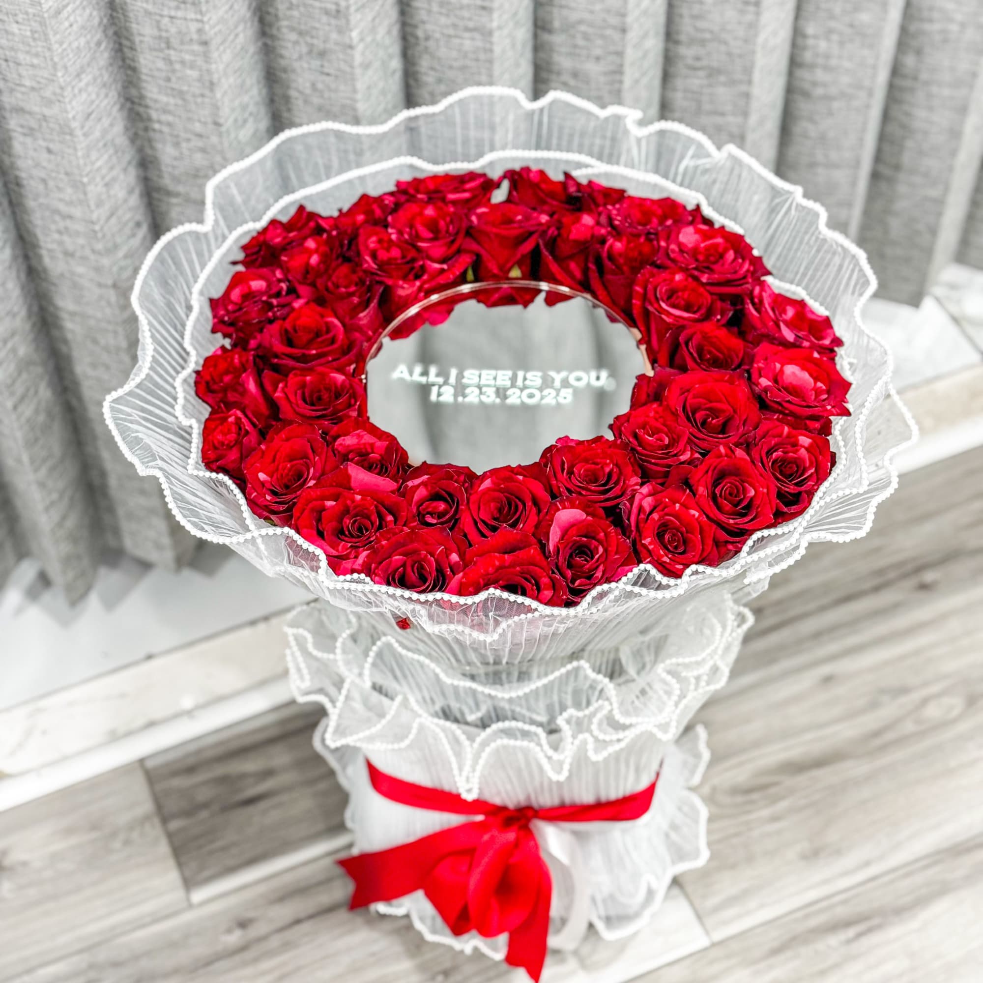 A dramatic ring of deep red roses arranged in a perfect circular