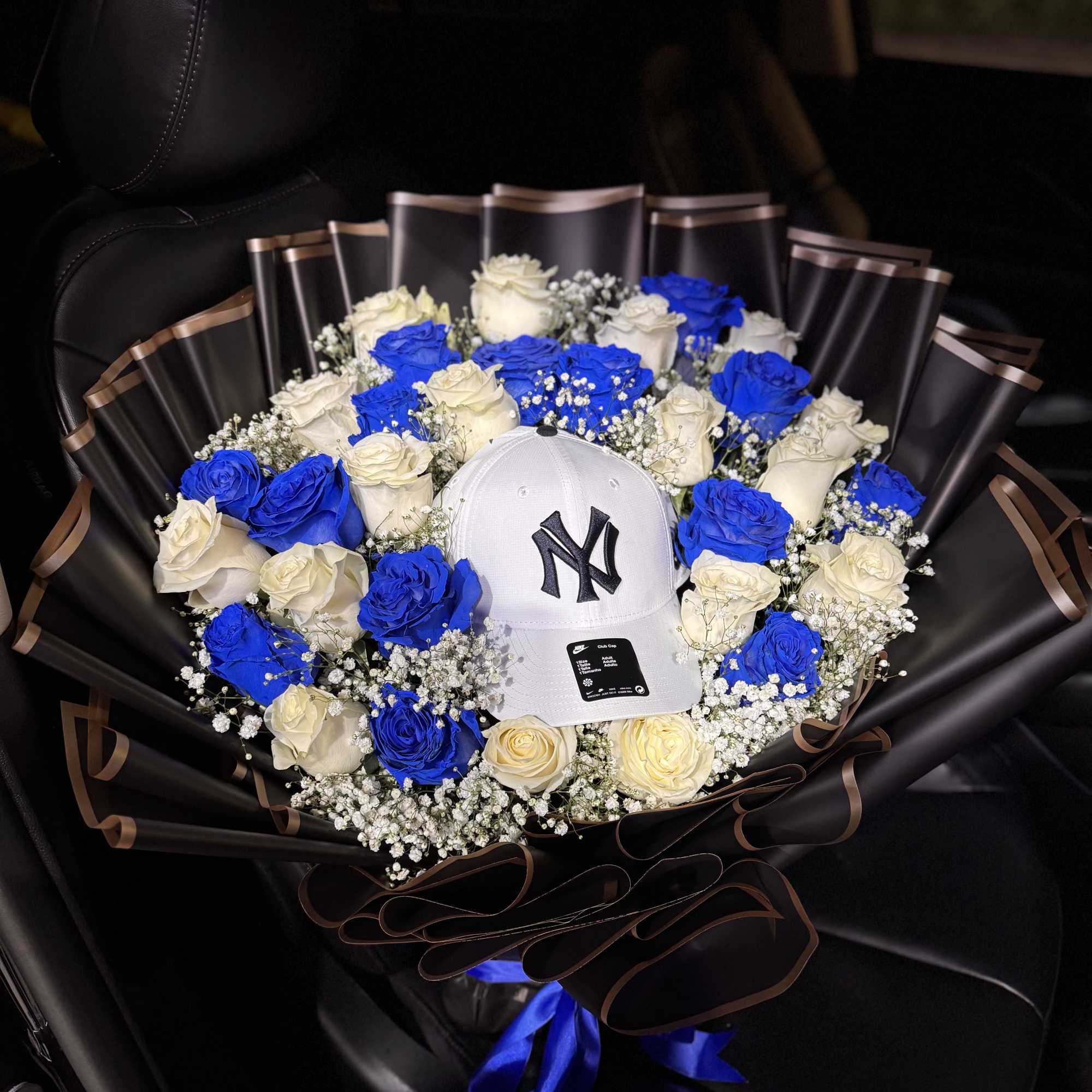 A bold ring of vivid blue and creamy white roses frames a