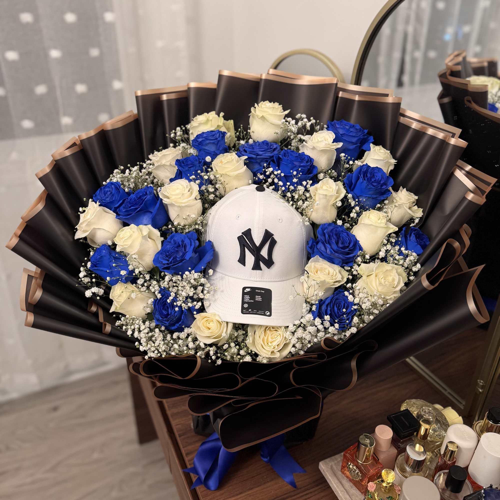 A bold ring of vivid blue and creamy white roses frames a