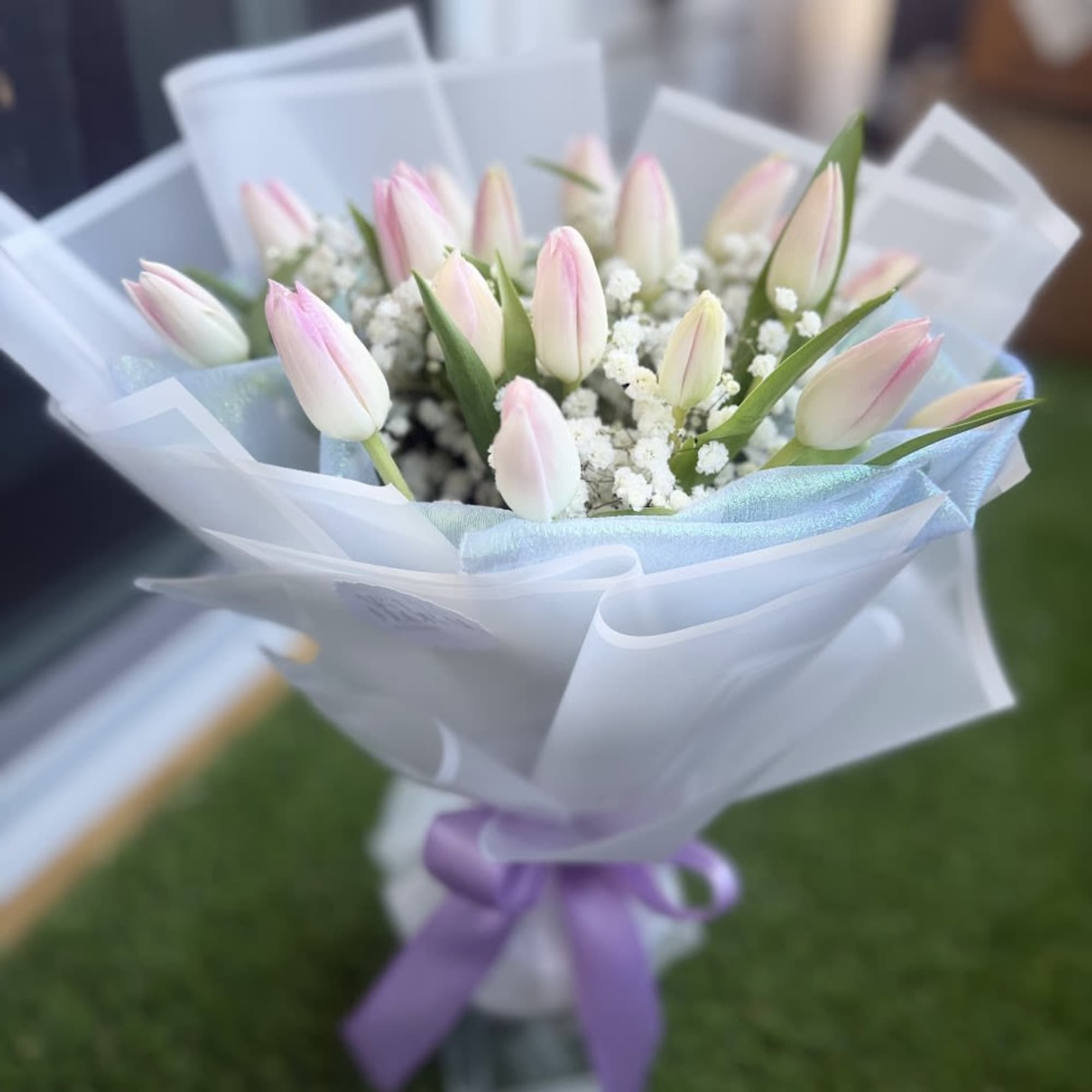 A delicate arrangement of pink tulips, carefully selected to convey tenderness, love