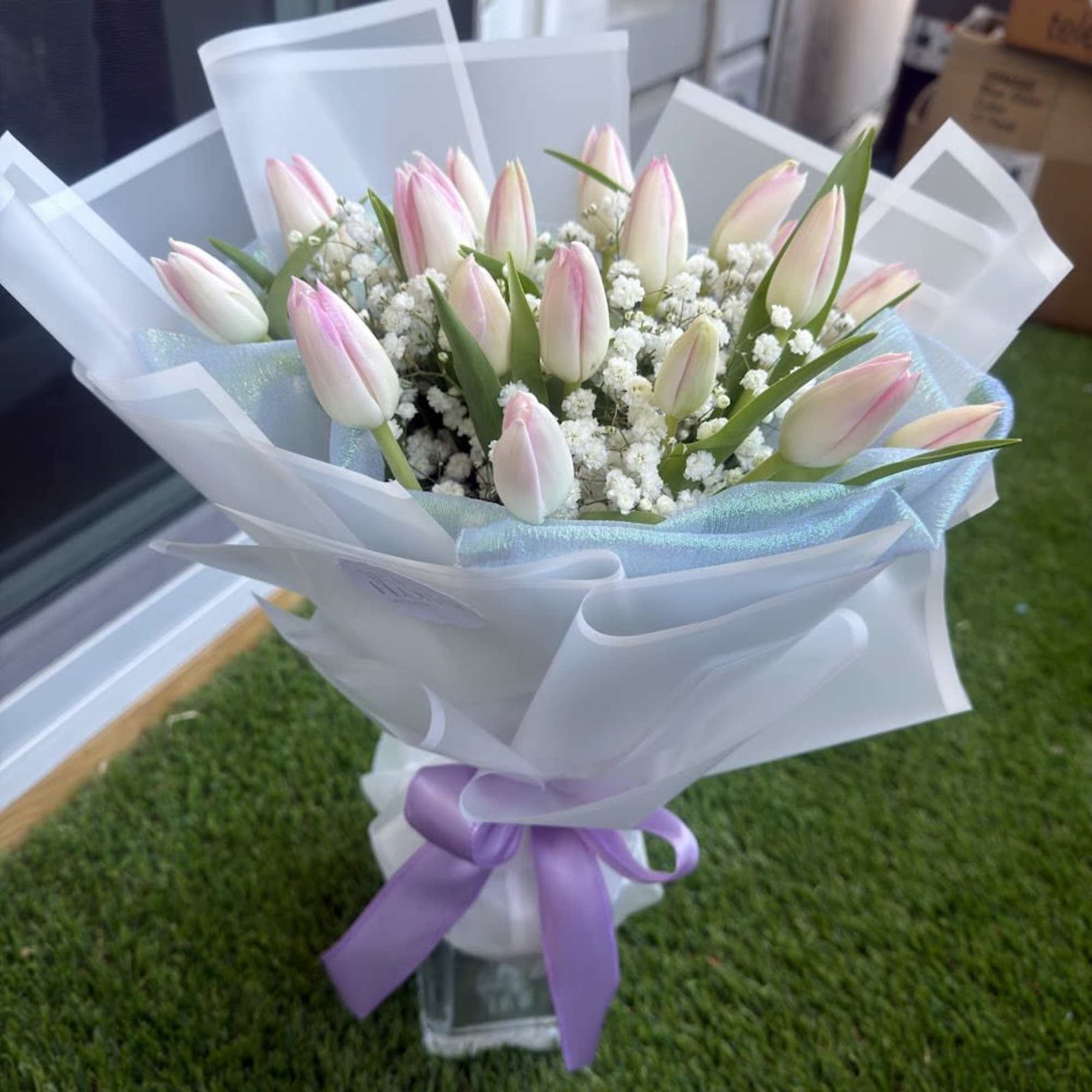 A delicate arrangement of pink tulips, carefully selected to convey tenderness, love