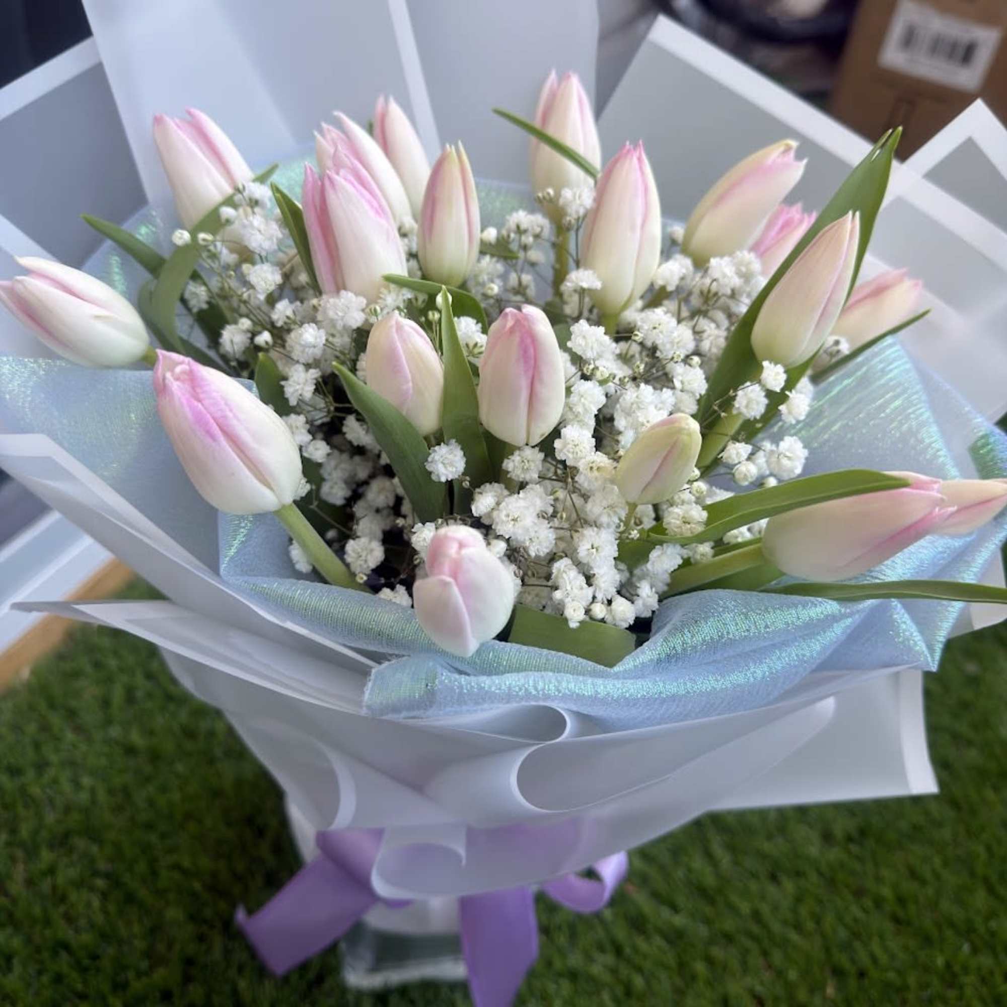 A delicate arrangement of pink tulips, carefully selected to convey tenderness, love