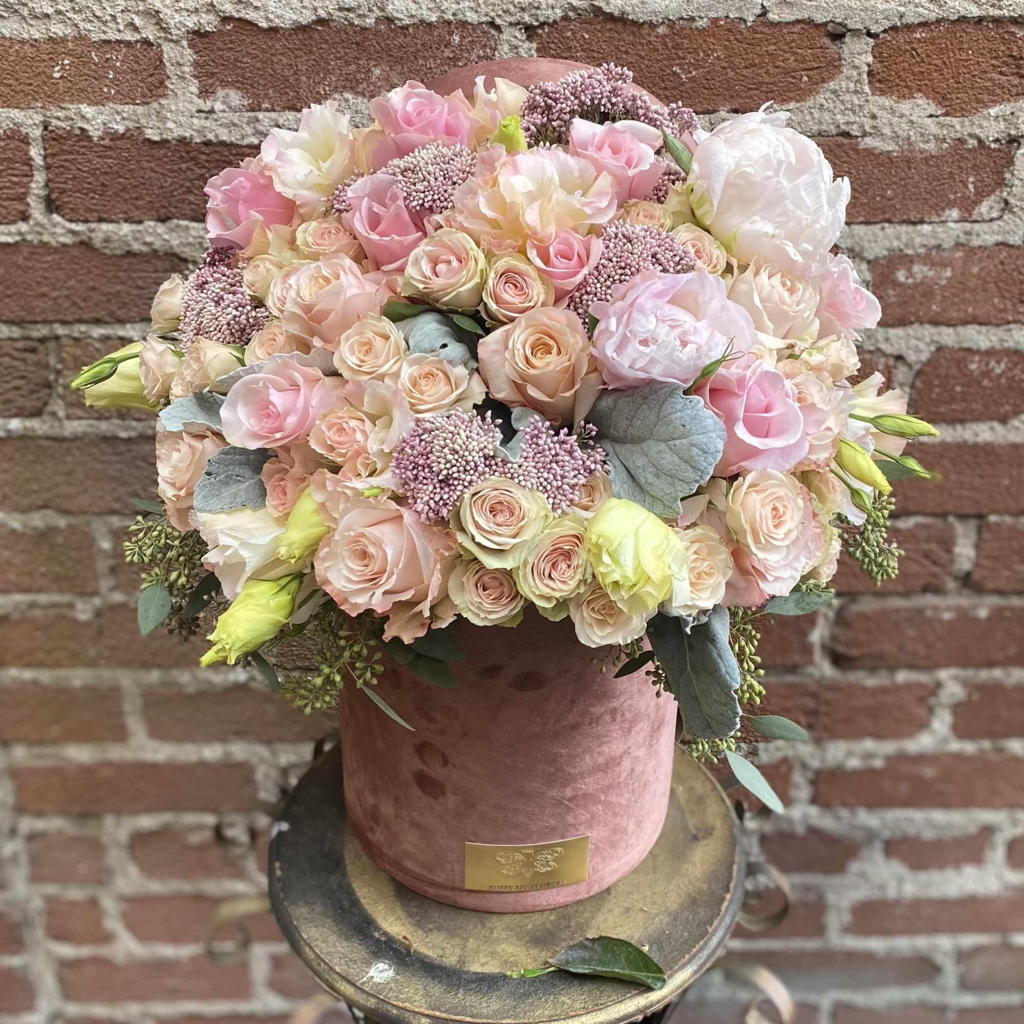 Pink and cream rose bouquet in a blush velvet hatbox