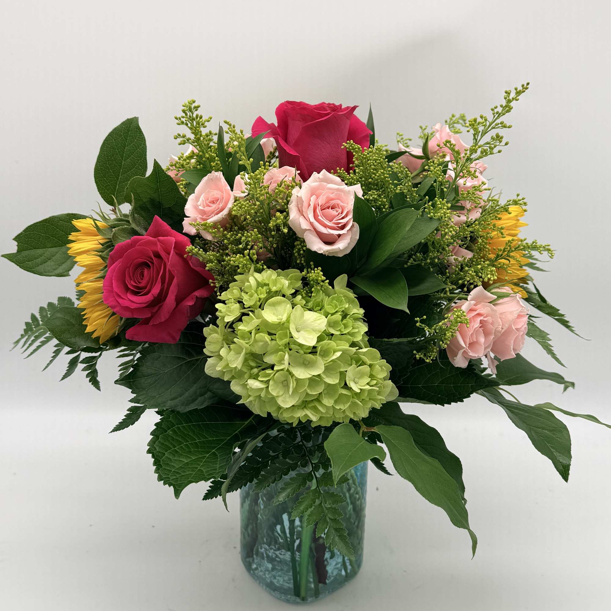 Bursting with color and freshness, this arrangement brings together vibrant roses, cheerful
