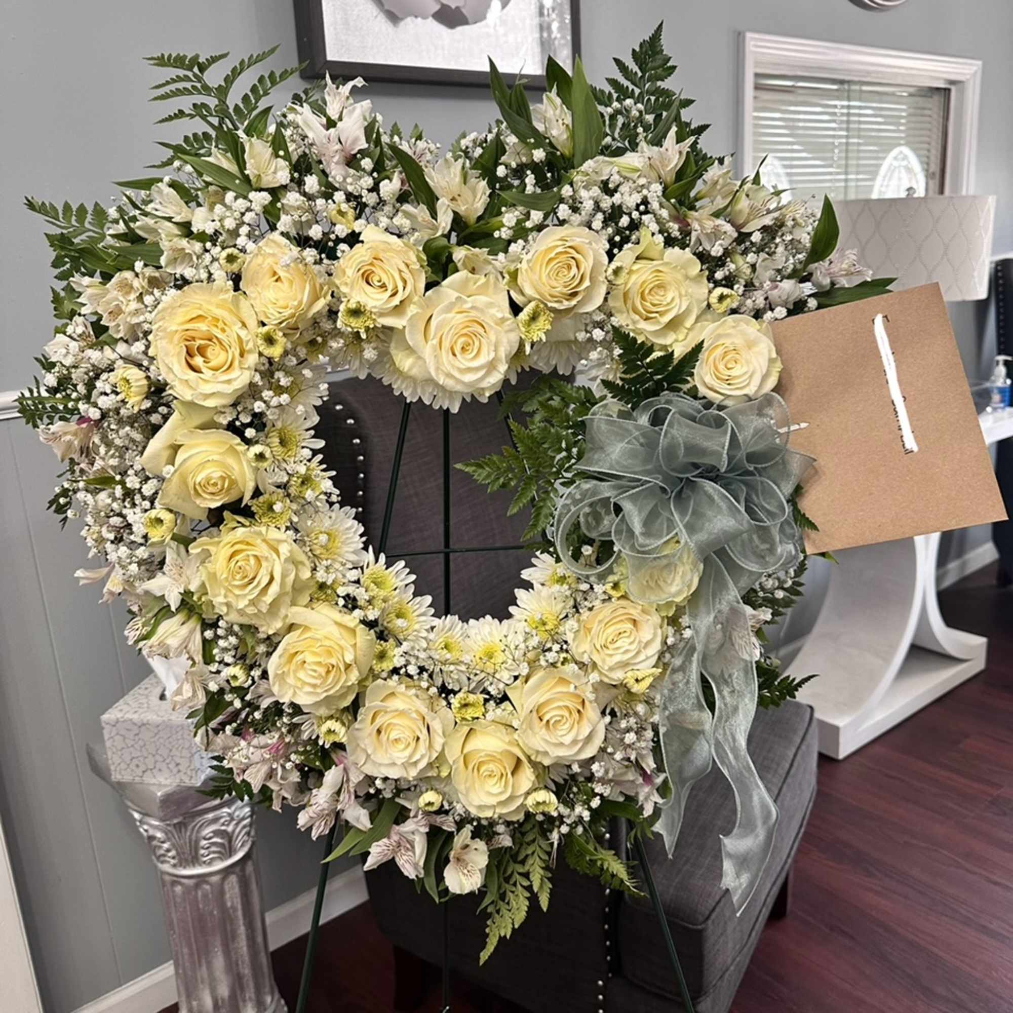 Our floral heart spray features a beautiful arrangement of white roses and