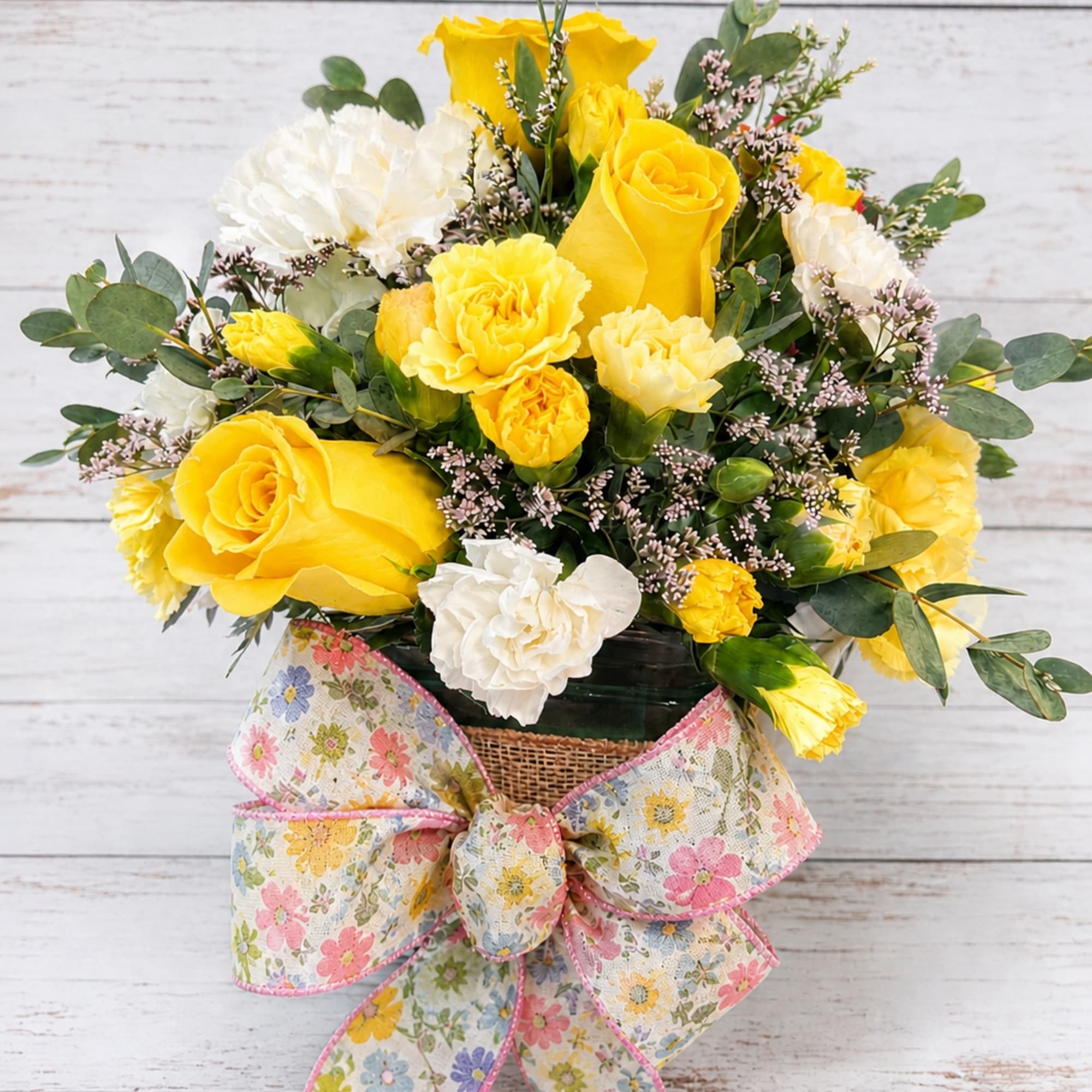 A cheerful cube arrangement bursting with sunshine and charm. Bright roses are