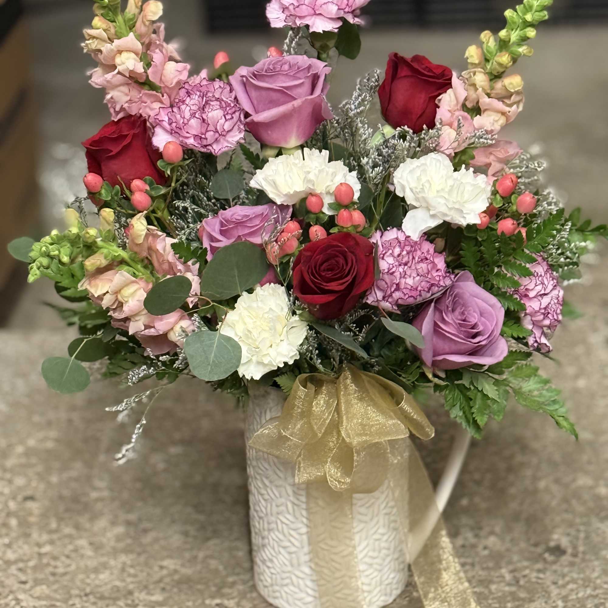 A decorative pitcher with fresh bloom with color and style of your