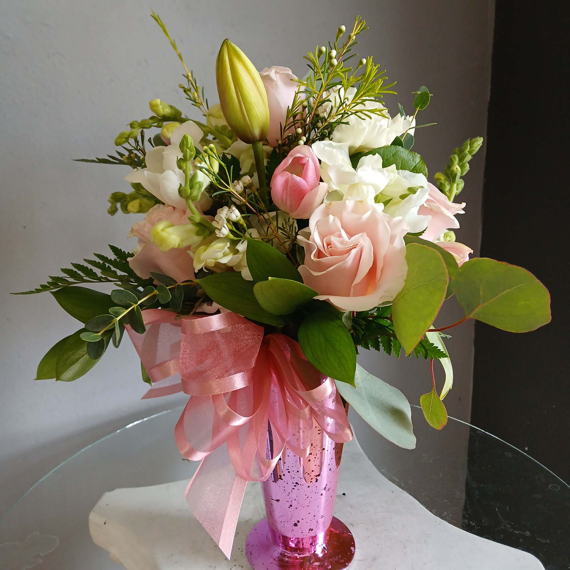 This beautiful flower arrangement of fresh mixed seasonal blooms is made by