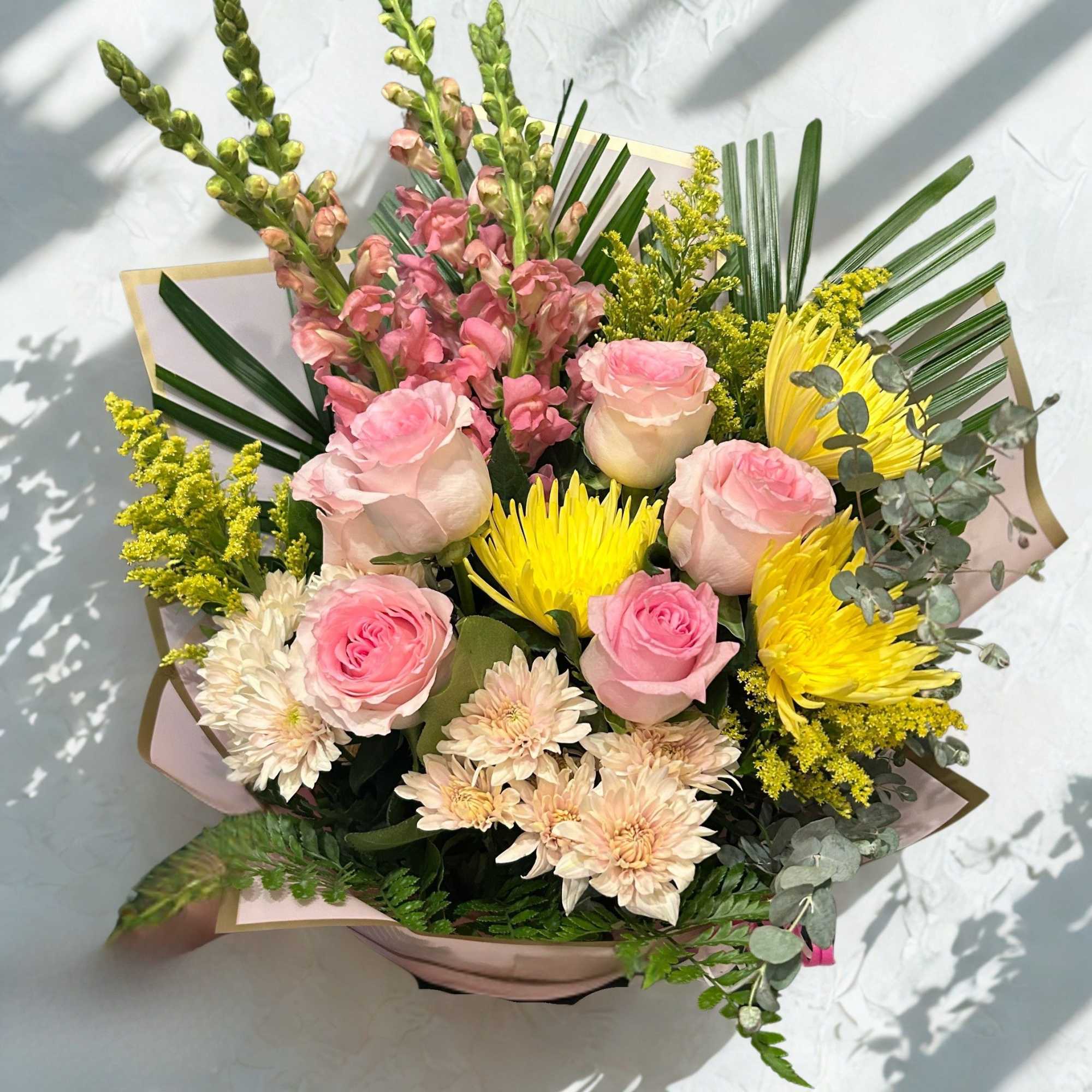 This mixed seasonal bouquet is a lively, romantic presence-perfect as a birthday
