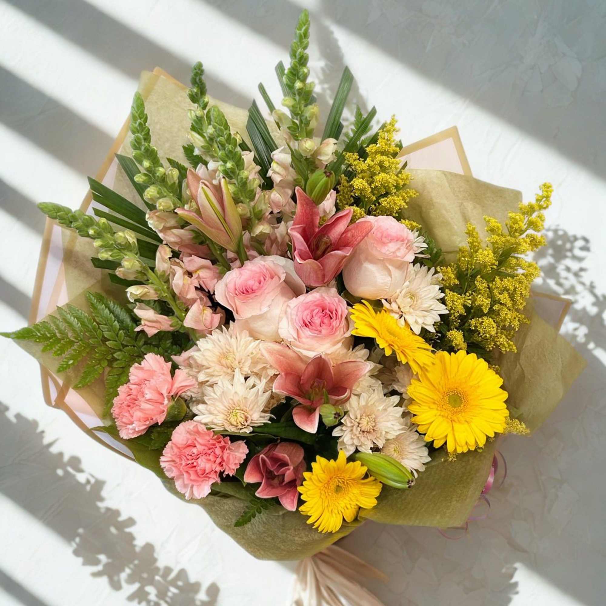 This mixed seasonal bouquet is a lively, romantic presence-perfect as a birthday
