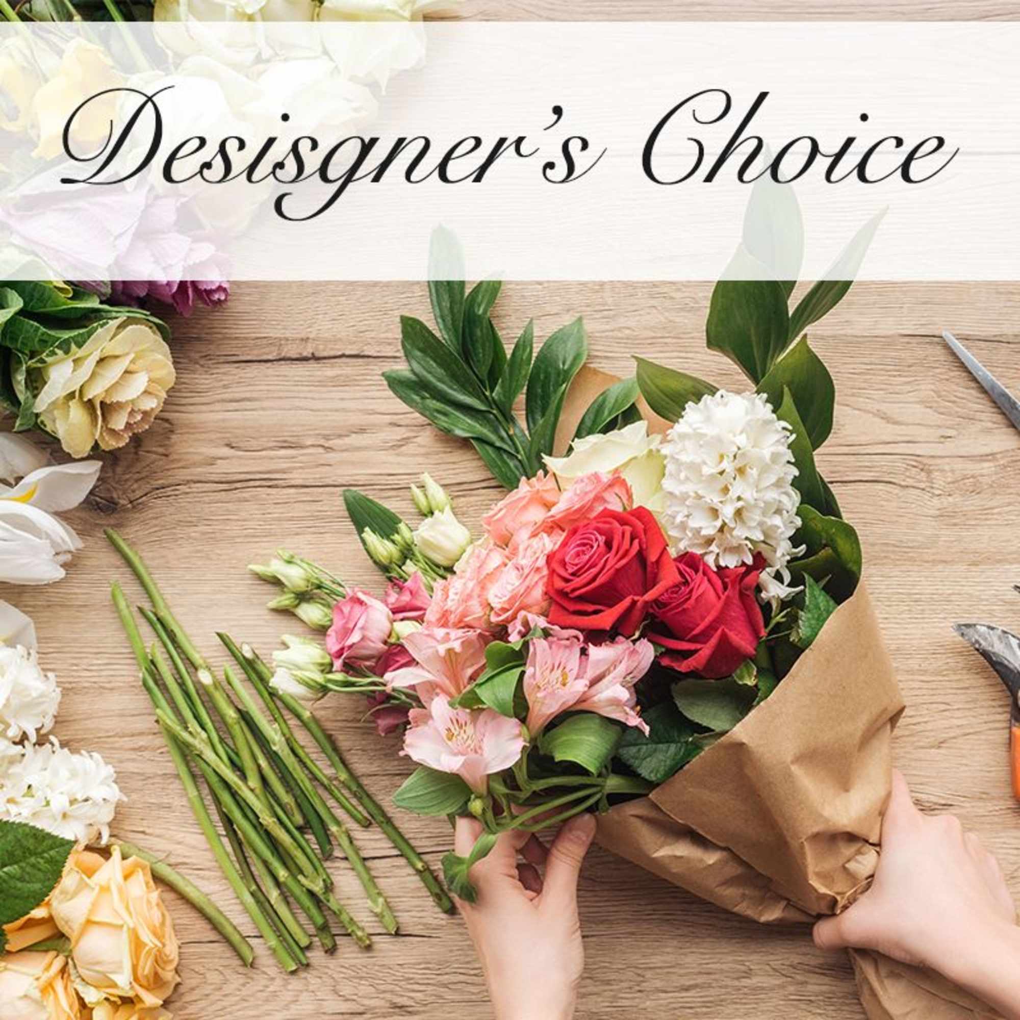 Hand-tied bouquet of mixed roses and pink flowers in brown paper