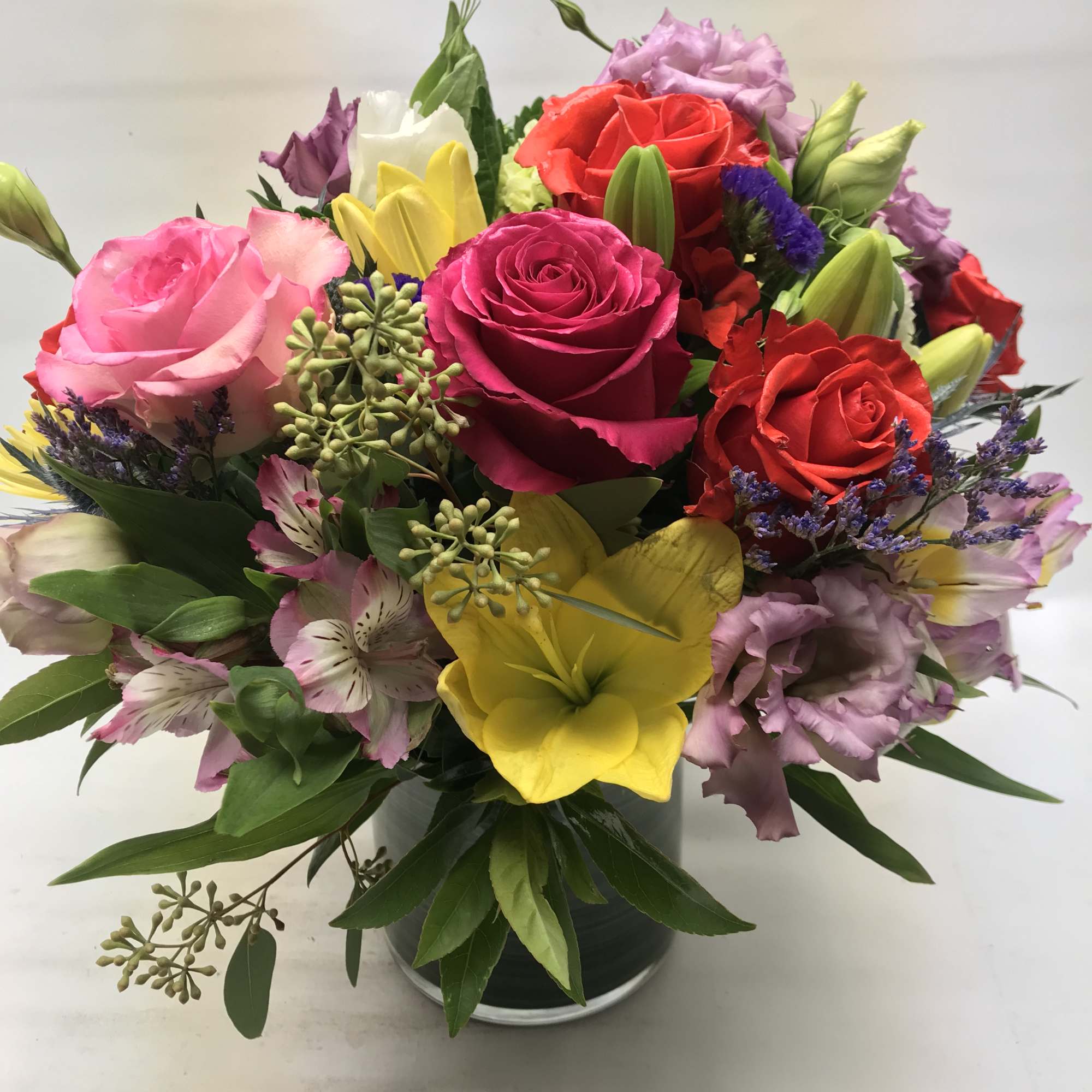 Mixed bouquet of roses, lilies, and alstroemeria in a vase
