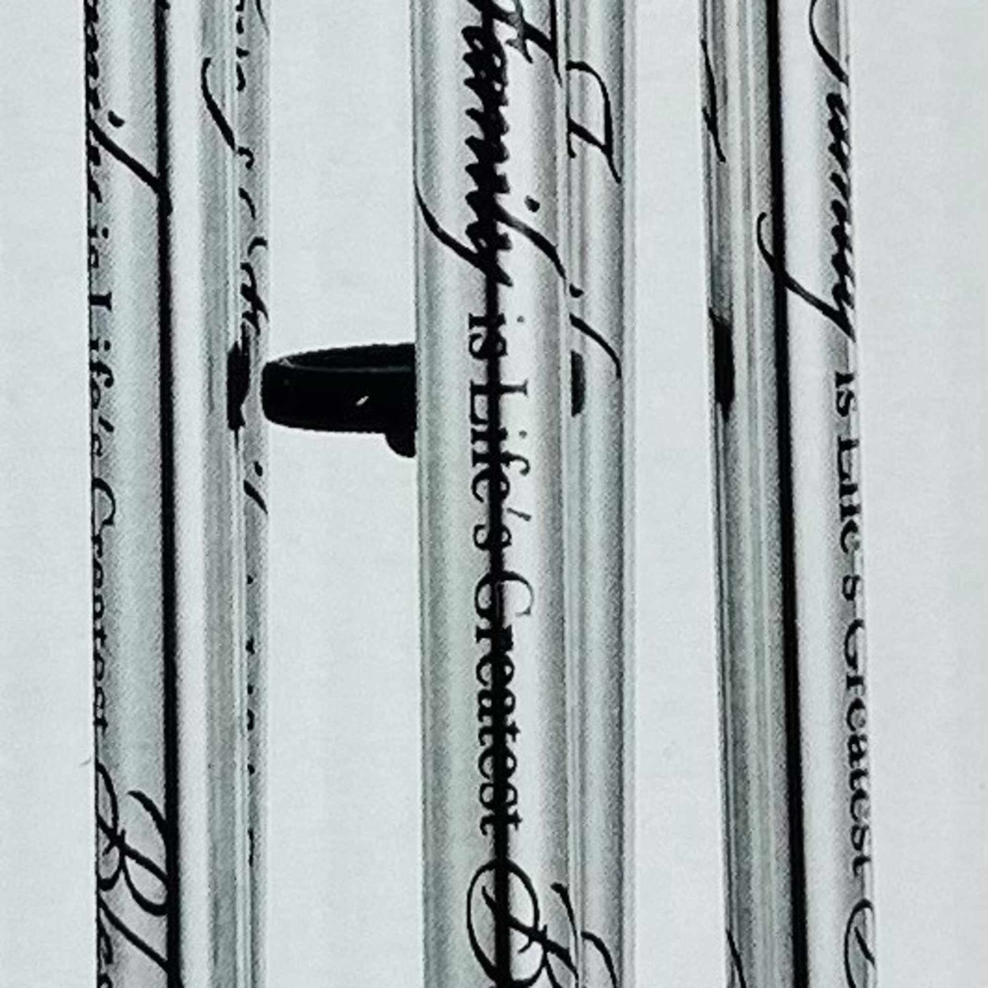 Black metal wind chime with engraved tubes and a LOVE pendant
