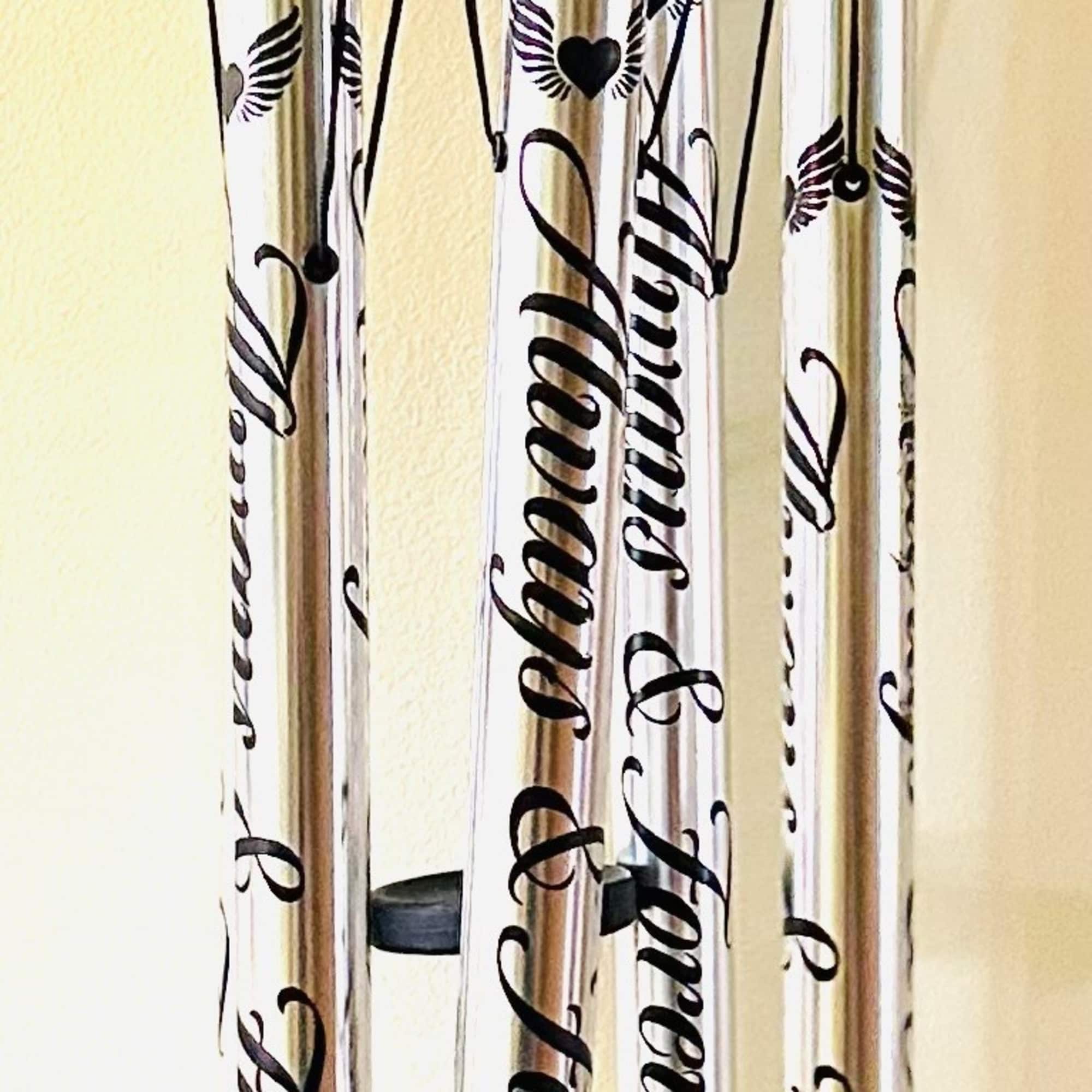 Black memorial wind chime with silver tubes and a heart pendant