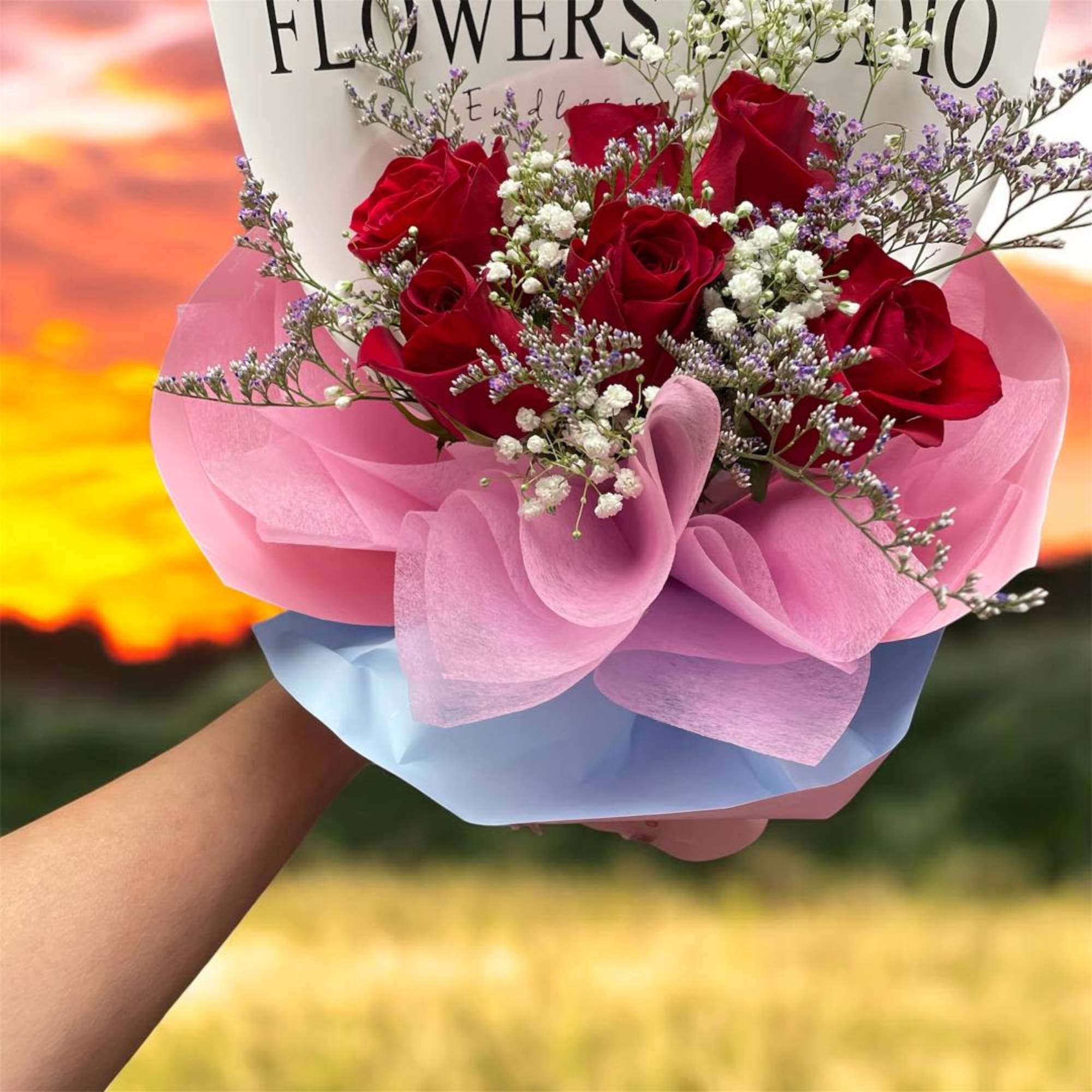 Bouquet of red roses with pink and blue wrapping