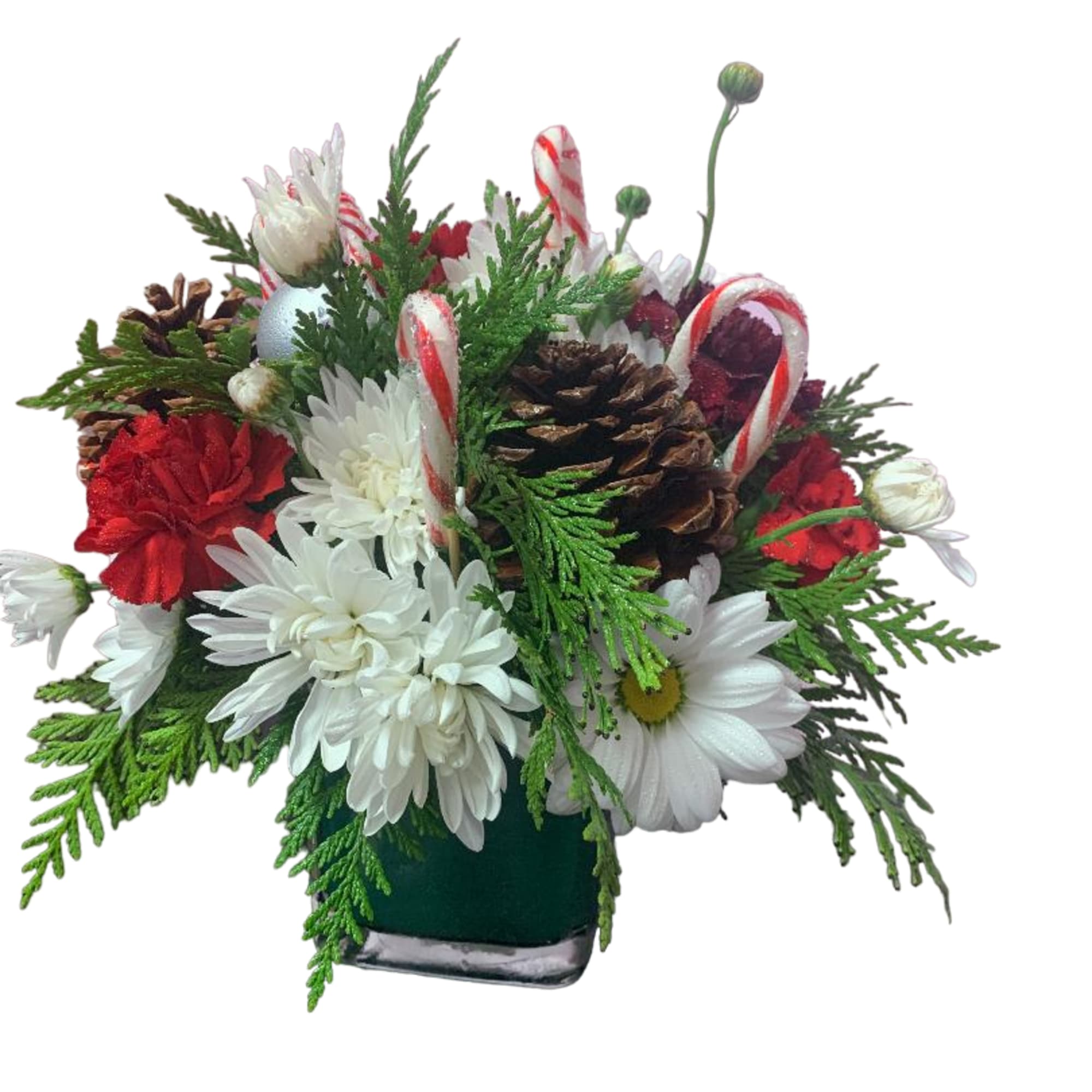 Holiday arrangement with white daisies, red flowers, pinecones, and candy canes in a vase