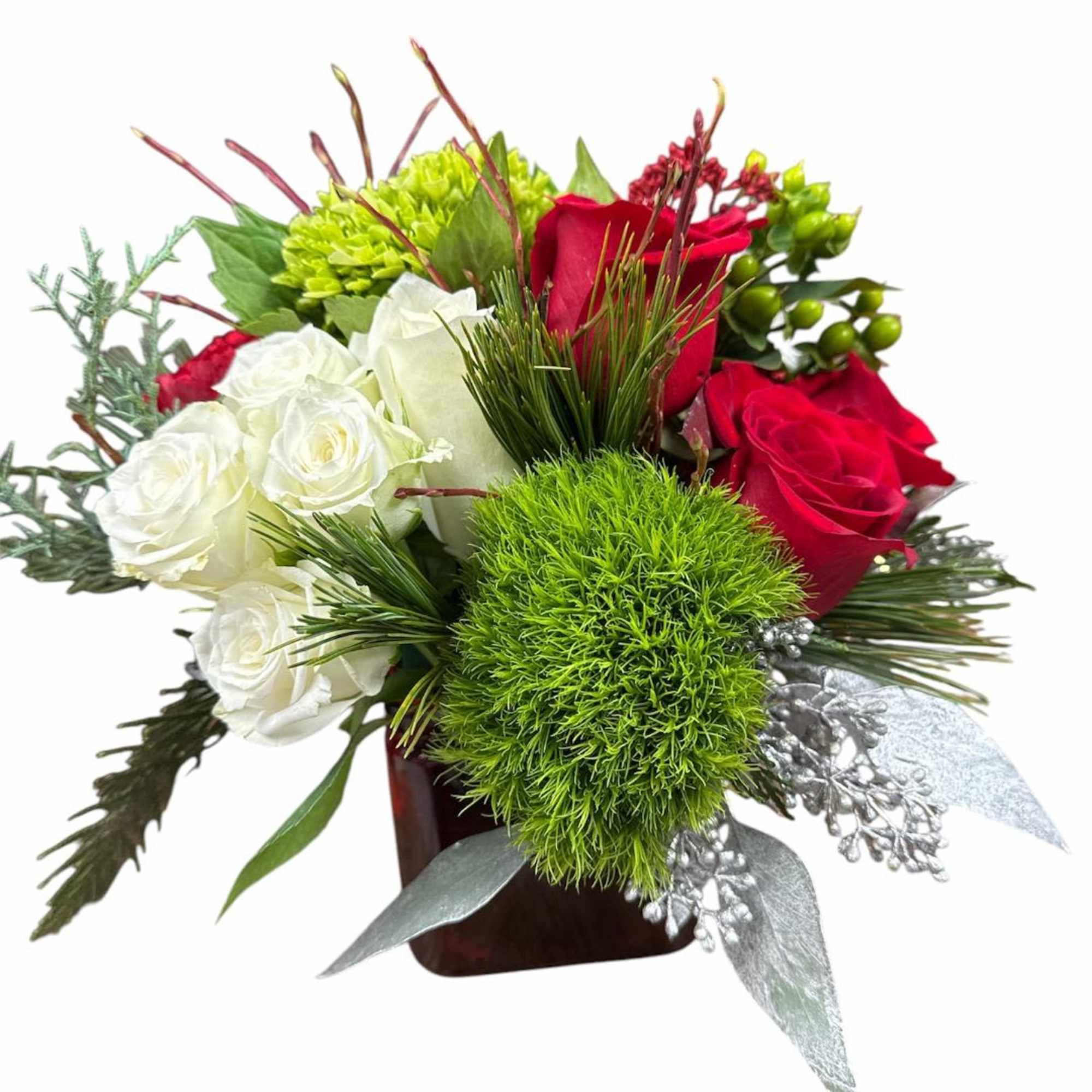 Red and white roses with green accents in a square vase