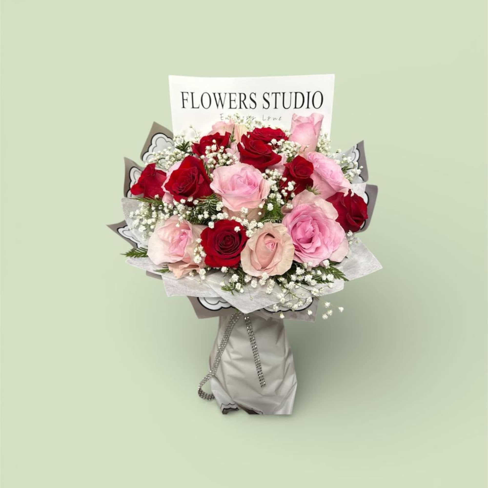 Bouquet of red and pink roses with baby's breath in wrapped paper