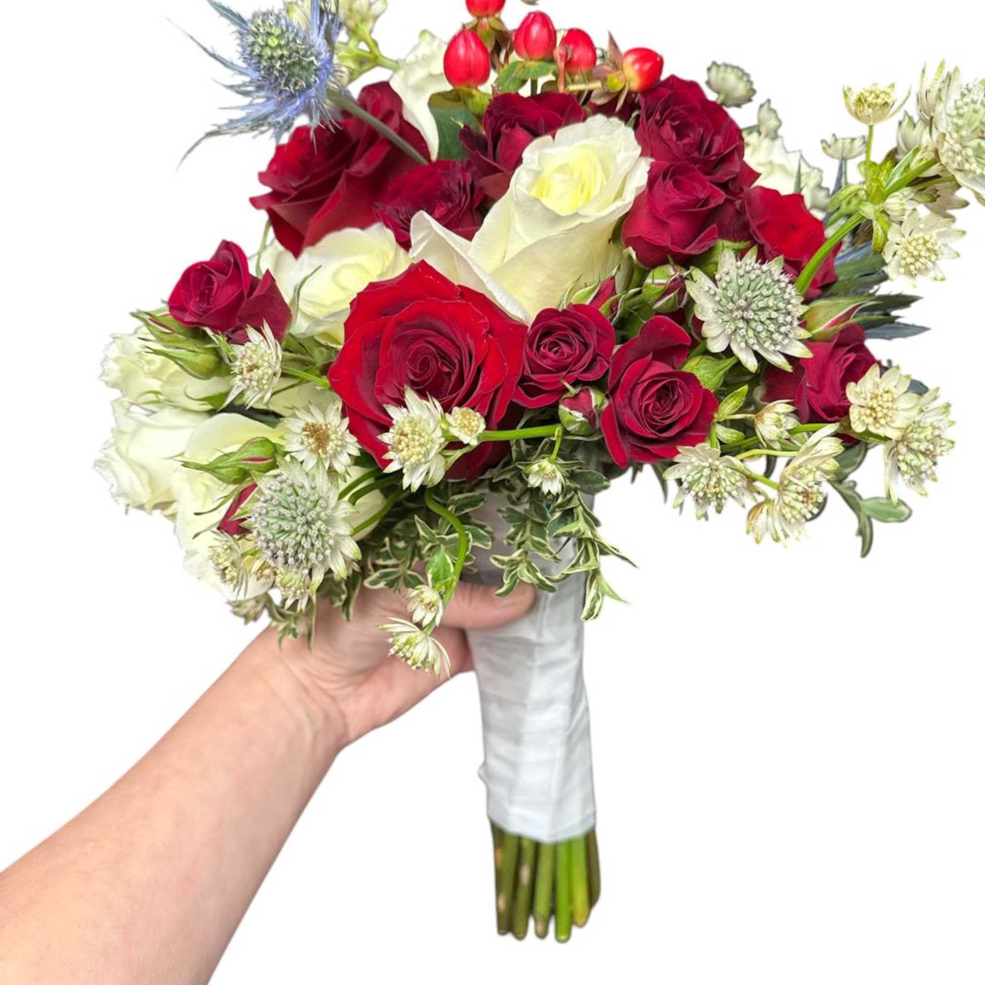 Handheld bouquet of red and white roses with small accent flowers